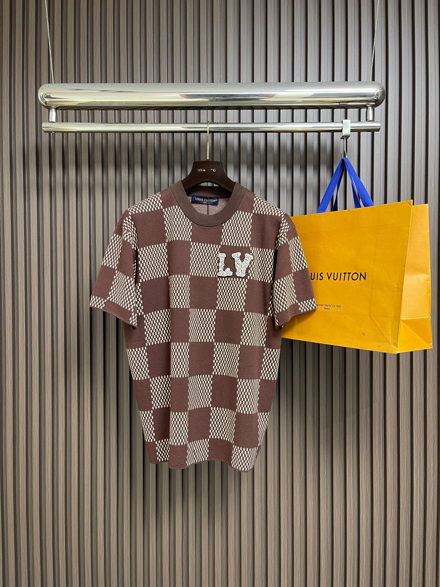NO:839833,LV  Checkered beaded woolen short-sleeved T-shirt. The wool is made of fully combed cotton yarn. The fabric is woven using a 47W imported Stoll 16-needle ultra-fine machine from Germany. It is woven at a parallel and even speed with reference to the original three-color jacquard weave. Each piece takes 270 minutes. During the weaving, 7 sand spits are used to alternately knit back and forth. The number of knitting rows on the front garment alone is as high as 6352... Only after random inspection can seam selection, washing, and original ordering be made by hand.  Labels, wash marks, details down to wash mark height, stitching, final ironing, and general inspection before packaging and shipment; it is not like those ordinary computerized flat knitting machines, which are run to the limit in order to rush goods for efficiency. The knitted garments have different stitch sizes, lettering, and pattern patterns. The overall wiring is straight and delicate, the fabric is comfortable and soft, and the color is consistent without color difference. It can be matched with the same style to create a fashionable look and control various occasions. Customized accessories, complete three standards, the same style for men and women!  Size S-XL S size Bust Shoulder width 44 Length 69 M size Bust 112 Shoulder width 46 Length 71 L size Bust 116 Shoulder width 48 Length 73 XL size Bust 120 Shoulder width 50 Length 7519860909LV 格纹钉珠毛织短袖T恤,毛料选用全精梳棉纱纱线,织片采用价值47W一台的德国进口斯托尔16针超细机器进行编织,参照原版三色提花组织进行平行均速编织,每件耗时270分钟,编织时由7把沙嘴来回交替进行编织,单单一块前服挂毛编织行数就高达6352行...抽查后才能进行缝挑,洗水,纯手工订原版主标,洗水唛,细节到洗标高度,针法,最后烫衣,总查后才可进行包装出货；不会像那些普通电脑横机织出来,为了效率赶货,速度开到极限,织出来的衣片针路大小不一、走字码、花片情况.整体走线平直细腻,面料舒适柔软,颜色一致无色差,能与同款搭配营造时尚造型,驾驭各种场合,定制辅料,三标齐全,男女同款！尺码S-XL S码 胸围 肩宽44 衣长69 M码胸围112肩宽46 衣长71 L码 胸围116肩宽48 衣长73 XL码胸围120肩宽50 衣长75,,louis vuitton,T-shirt,tees，t-shirt,,Men's clothing