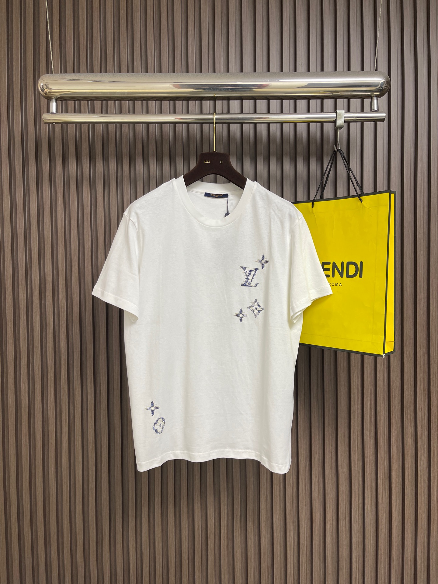 NO:842638,LV  Knitted short-sleeved T-shirt with monogram and flower color embroidery. This LV style knitted short-sleeved T-shirt is made of high-count fine knitted fabrics. It feels soft and skin-friendly, breathable and comfortable with good drape. It is not easy to pill and deform after long-term wear. The body uses hot-drilling technology to create the brand logo and classic element patterns. The diamond decorations are arranged neatly and firmly, shining with exquisite luster and not easy to fall off. Round  The collar adopts reinforced rib technology, which fits the neck and is not easy to loosen. The cuffs and hem are flat and seamed, and the wiring is neat and neat. The overall shape is loose and comfortable, the tailoring is simple and elegant, and the details show exquisite texture. It can easily create a high-end street fashion style and is suitable for many scenes. The overall wiring is straight and delicate, the fabric is comfortable and soft, and the colors are consistent and without color difference.  It can be matched with the same style to create a fashionable look, and can be used in various occasions. Customized accessories, complete with three standards, same style for men and women!  Size S-XL S size Bust 108 Shoulder width 47 Length 70 M size Bust 112 Shoulder width 49 Length 72 L size Bust 116 Shoulder width 51 Length 7419860909LV 字母花卉拼色刺绣针织短袖T恤,这款LV风针织短袖T恤,甄选高支细腻针织面料,触感软糯亲肤,透气舒适且垂坠感佳,久穿不易起球变形.衣身采用烫钻工艺打造品牌标识与经典元素图案,钻饰排列整齐牢固,闪耀精致光泽,不易脱落.圆领采用加固罗纹工艺,贴合颈部不易松垮,袖口与下摆做平整锁边处理,走线工整利落.整体版型宽松舒适,剪裁简约大气,细节尽显精致质感,轻松打造高级街头时尚风格,适配多场景穿搭.整体走线平直细腻,面料舒适柔软,颜色一致无色差 能与同款搭配营造时尚造型,驾驭各种场合,定制辅料,三标齐全,男女同款！尺码S-XL S码 胸围108肩宽47 衣长70 M码胸围112 肩宽49 衣长72 L码 胸围116 肩宽51 衣长74 XL码胸围120 肩宽53 衣长76,,louis vuitton,T-shirt,tees，t-shirt,,Men's clothing