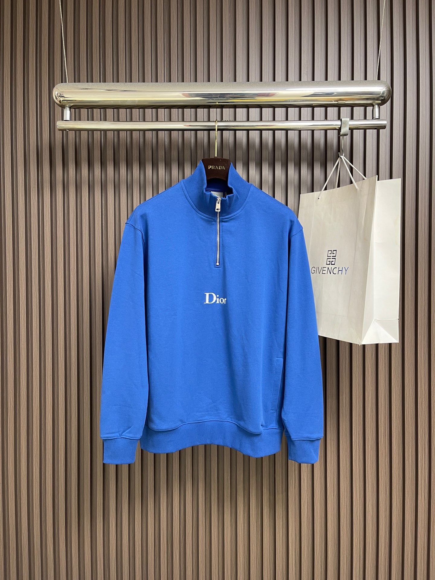 NO:911597,Dior  The classic logo embroidered half-zip stand-up collar jacket is made of 26-count double-yarn S plush bottom fleece fabric structure with a weight of 380g㎡. It is matched with 21-count 1x1 ribs of the same weight with a weight of 470g㎡. It is used for the cuffs and hem. Its extremely high weight ensures the ultimate thickness, stiffness and deformation resistance of these closing parts, which is consistent with the shape of the body.  It forms a unified and strong outline. The fabric is a heavyweight high-quality sweatshirt fabric. 26 double yarns form a smooth, delicate and strong outer surface of the fabric, ensuring good color fastness and appearance. The 10S plush bottom is processed through a precise fleece or brushing process to form a layer of rich, dense and uniform velvet on the inside of the fabric. This makes the sweatshirt also have an external crispness  The bone texture and the ultimate soft and warm touch inside. White tone twill stitch embroidery process. stitch embroidery is a straight line embroidery with stitches closely connected and evenly arranged. It is often used to outline clear and sharp outlines. This stitch method is used to embroider a twill stripe pattern with a certain angle and width. Use white embroidery thread to follow the preset diagonal trajectory with high-density stitches.  The feet are precisely embroidered. On the high-weight fabric base, a simple, delicate and highly three-dimensional line decoration is created. The contrast between white and fabric color is sharp, and the slightly convex texture brought by the embroidery adds a visual and tactile layer, effectively improving the exquisite style of the basic sweatshirt. The overall line routing is straight and delicate, the fabric is comfortable and soft, and the color is consistent without color difference.  It can be matched with the same style to create a fashionable look, and can be used in various occasions. Customized accessories, complete with three standards, same style for men and women!  Sizes M-XXL,,dior,hoodie,sweatshirts,jackets & coats,19860909Dior 经典标志刺绣半拉链立领外套,采用26支双纱面S毛绒底的起绒面料结构,克重为380g㎡,搭配同样重磅的21支1x1罗纹,克重为470g㎡,用于袖口及底边其极高的克重确保了这些收口部位极致的厚实度、挺括度和抗变形能力,与衣身形成统一而坚固的轮廓.面料属于重磅高品质卫衣面料,26支双纱构成面料光滑、细腻且坚固的外表面,确保良好的色牢度和外观.10S毛绒底经过精密的抓绒或刷绒工艺,在面料内侧形成一层丰厚、浓密且均匀的绒毛.这使得卫衣同时具备外部的挺括骨感与内部极致的柔软温暖触感.白色调斜纹挨针刺绣工艺,挨针刺绣是一种针脚紧密相连、排列均匀的直线绣,常用于勾勒清晰锐利的轮廓.运用了这种针法来绣制具有一定角度和宽度的斜纹条纹图案.使用白色绣线按照预设的斜向轨迹,以高密度针脚进行精准车绣.在高克重面料基底上,创造出简洁、精致且极具立体感的线条装饰.白色与面料色的对比鲜明,而刺绣带来的微凸质感则增添了视觉和触觉的层次,有效提升了基础款卫衣的精致格调.整体走线平直细腻,面料舒适柔软,颜色一致无色差 能与同款搭配营造时尚造型,驾驭各种场合,定制辅料,三标齐全,男女同款！尺码M-XXL,,dior,hoodie,sweatshirts,jackets & coats,,Men's clothing