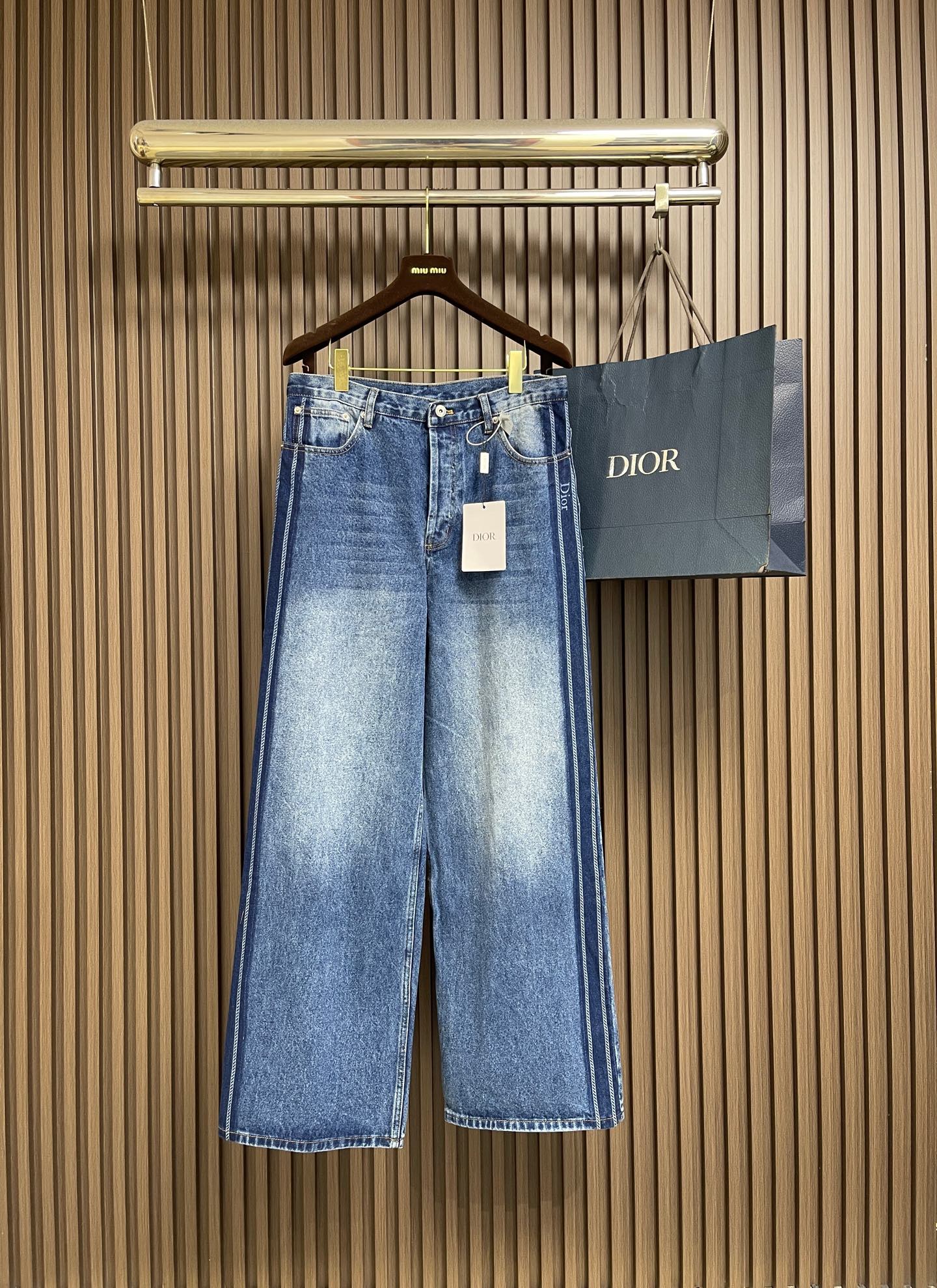 NO:950661,Dior  Side Stripe Jacquard Logo Leather Label Jeans. This style of DIOR Side Stripe Jacquard Logo Leather Label Jeans is made of heavy-weight washed denim fabric. The fabric is stiff, stylish, flexible and wear-resistant. It has been treated with a heavy-duty gradient stonewashing process.  , showing a natural retro blue gradient layering, weakening the harsh industrial feel. An exclusive striped jacquard webbing is implanted on the side of the trousers, and the brand's dark logo is embedded. The webbing is neatly and firmly stitched, the wiring is even and dense, and it is not easy to fall off and crack after a long time. The back waist is equipped with original leather  Branded leather label, exquisite cutting, regular stitching, enhance overall recognition. The version adopts a loose straight wide-leg cut, the waistband adopts a classic five-pocket denim structure, the hardware buttons are precision hemmed, the pockets are reinforced with hemming technology to enhance durability, and the trouser legs are flat and lock-stitched.  The body cut is neat and drapey, taking into account retro tones and practicality for daily wear. The garment has a stable shape and is not easily deformed and bulging after washing. It is suitable for a variety of body shapes and has both texture and wearing comfort. The overall routing is straight and delicate, the fabric is comfortable and soft, and the color is consistent without color difference.  Can be matched with the same style to create a fashionable look, to suit various occasions, customized accessories, complete with three standards!  Size 30-32-34-36 Size 30 Pants length 113 Hips 106 Waist 83 Size 32 Pants length 114 Hips 110 Waist 87 Size 34 Pants length 115 Hips 114 Waist 91 Size 36 Pants length 116 Hips 118 Waist  95,,dior,jeans,19860909Dior 侧边条纹提花Logo皮标牛仔裤,本款DIOR侧边条纹提花Logo皮标牛仔裤选用重磅水洗牛仔面料织造而成,面料挺括有型且柔韧耐磨,经过重工渐变做旧石磨水洗工艺处理,呈现自然复古的蓝调渐变层次感,弱化生硬工业感.裤身侧边植入专属条纹提花织带,内嵌品牌暗纹标识,织带车线工整牢固,走线均匀密实,经久不易脱线开裂.后腰配备原装皮质品牌皮标,裁切精致,缝线规整,提升整体辨识度.版型采用宽松直筒阔腿剪裁,腰头采用经典五袋牛仔结构,五金纽扣锁边精密,口袋加固包边工艺提升耐用度,裤脚平整锁缝,整体剪裁垂坠利落,兼顾复古调性与日常穿搭实用性,成衣定型稳定,水洗后不易变形鼓包,适配多种身形,兼具质感与穿着舒适度.整体走线平直细腻,面料舒适柔软,颜色一致无色差 能与同款搭配营造时尚造型,驾驭各种场合,定制辅料,三标齐全！尺码30-32-34-36 30码 裤长 113 臀围 106 腰围 83 32码 裤长 114 臀围 110 腰围 87 34码 裤长 115 臀围 114 腰围 91 36码 裤长 116 臀围 118 腰围 95,,dior,jeans,,Men's clothing