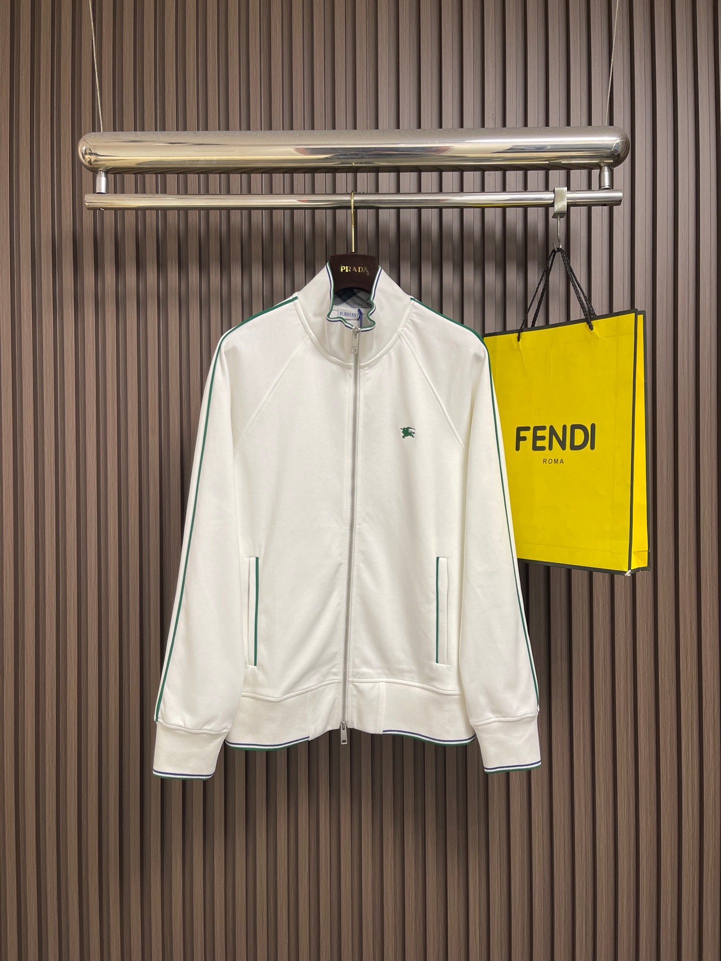 NO:950745,Burberry  Stand-up collar line tennis long-sleeve zipper jacket. This Burberry SS26 high-collar tennis sports jacket is made of high-count combed cotton knitted fabric, which has been softened and sanded. It has a delicate touch and skin-friendly feel, is breathable and sweat-wicking, is not easy to pill and harden after long-term wear, and has a crisp fit.  It is not easy to collapse and deform. The body is trimmed with retro green contrasting fine webbing. The lines are straight and symmetrical, and the segmentation is neat and exquisite. It has a classic tennis retro style. The war horse logo on the chest is made of fine three-dimensional embroidery technology. The stitches are dense and compact, and the outline is clear and full. Washed  It is not easy to fall off the thread. The inside of the stand-up collar is equipped with a classic plaid lining. The collar shape is firm and not easy to collapse. The central metal zipper is smooth and durable, and the pull is smooth and not stuck. The vertical pockets on both sides are sewn with reinforced edges, making the bag shape durable and stiff without deformation. The hem and cuffs are bumped.  Colored ribbed cuffs, rebound and stable fit to the body shape. The overall loose tailoring accommodates all body shapes, and the entire car is double-threaded with precision sewing, taking into account the texture of a light luxury brand, sports comfort and daily commuting wear attributes. The overall routing is straight and delicate, the fabric is comfortable and soft, and the colors are consistent without color difference.  Can be matched with the same style to create a fashionable look, to suit various occasions, customized accessories, complete with three standards!  Sizes S-XL,,burberry,jackets & coats,jackets & coats,19860909Burberry 立领线条网球长袖拉链夹克外套,这款博柏利SS26高领网球运动夹克选用高支精梳棉质针织面料,经过柔化磨毛后整处理,触感细腻亲肤,透气排汗,长久穿着不易起球发硬,版型挺括不易软塌变形.衣身搭配复古绿色撞色细织带镶边,走线笔直对称,分割车工工整精致,经典网球运动复古格调.胸口战马标识采用精细立体刺绣工艺,针脚密实紧凑,轮廓清晰饱满,水洗不易脱线脱落.立领内侧搭载经典格纹内衬,领型定型牢固不易外翻塌陷,中央金属拉链顺滑耐久,拉动流畅不卡顿.两侧竖插袋做加固包边缝制,袋型持久挺括不变形,下摆与袖口采用撞色罗纹收口,回弹稳定贴合身形.整体宽松剪裁包容各类身形,全车双线精密缝制,兼顾轻奢品牌质感、运动舒适度与日常通勤穿搭属性.整体走线平直细腻,面料舒适柔软,颜色一致无色差 能与同款搭配营造时尚造型,驾驭各种场合,定制辅料,三标齐全！尺码S-XL,,burberry,jackets & coats,jackets & coats,,Men's clothing