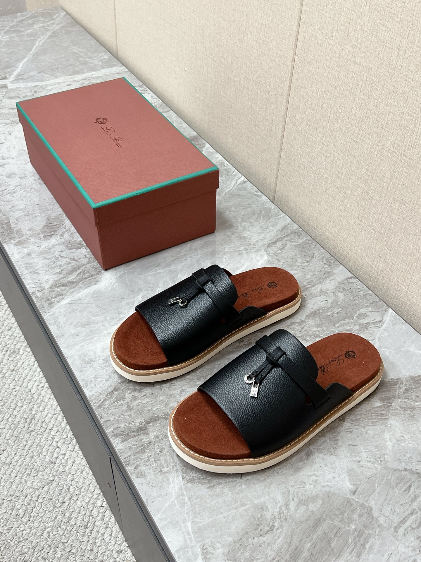 NO:889942,Loro Piana is the latest old-money casual slippers for spring and summer. Loro Piana Runway series of one-line casual slippers are the brand's iconic old-money style men's summer shoes. It focuses on light luxury and relaxed wear. Linen shorts, casual trousers, jeans, and vacation suits are suitable for minimalist luxury and old-money relaxed style. A single belt on the upper is matched with the brand's mini metal lock buckle. It is simple and not exaggerated. The core of brand recognition. The belt can be fine-tuned.  Suitable for different instep widths. Upper suede calfskin. Matte and delicate. Retro style. Original foam outsole. Size 39-46 (45 and 46 non-returnable). Slippers, loro piana, slippers, shorts, jeans, cowhide.19860909Loro Piana 诺悠翩雅春夏最新款老钱风休闲拖鞋 超多明星网红种草 Loro Piana Runway系列一字休闲凉拖 是品牌标志性老钱风男士夏日鞋款 主打轻奢松弛穿搭 亚麻短裤、休闲西裤、牛仔裤、度假套装,契合极简轻奢、老钱松弛风 鞋面单条皮带搭配品牌迷你金属锁扣 简约不浮夸 品牌辨识度核心 皮带可微调松紧 适配不同脚背宽度 鞋面牛反绒翻毛皮小牛皮 哑光细腻 复古格调突出 原版发泡大底码数39-46（45 46不退换）,拖鞋,loro piana,slippers,shorts,jeans,cowhide,Women's Shoes