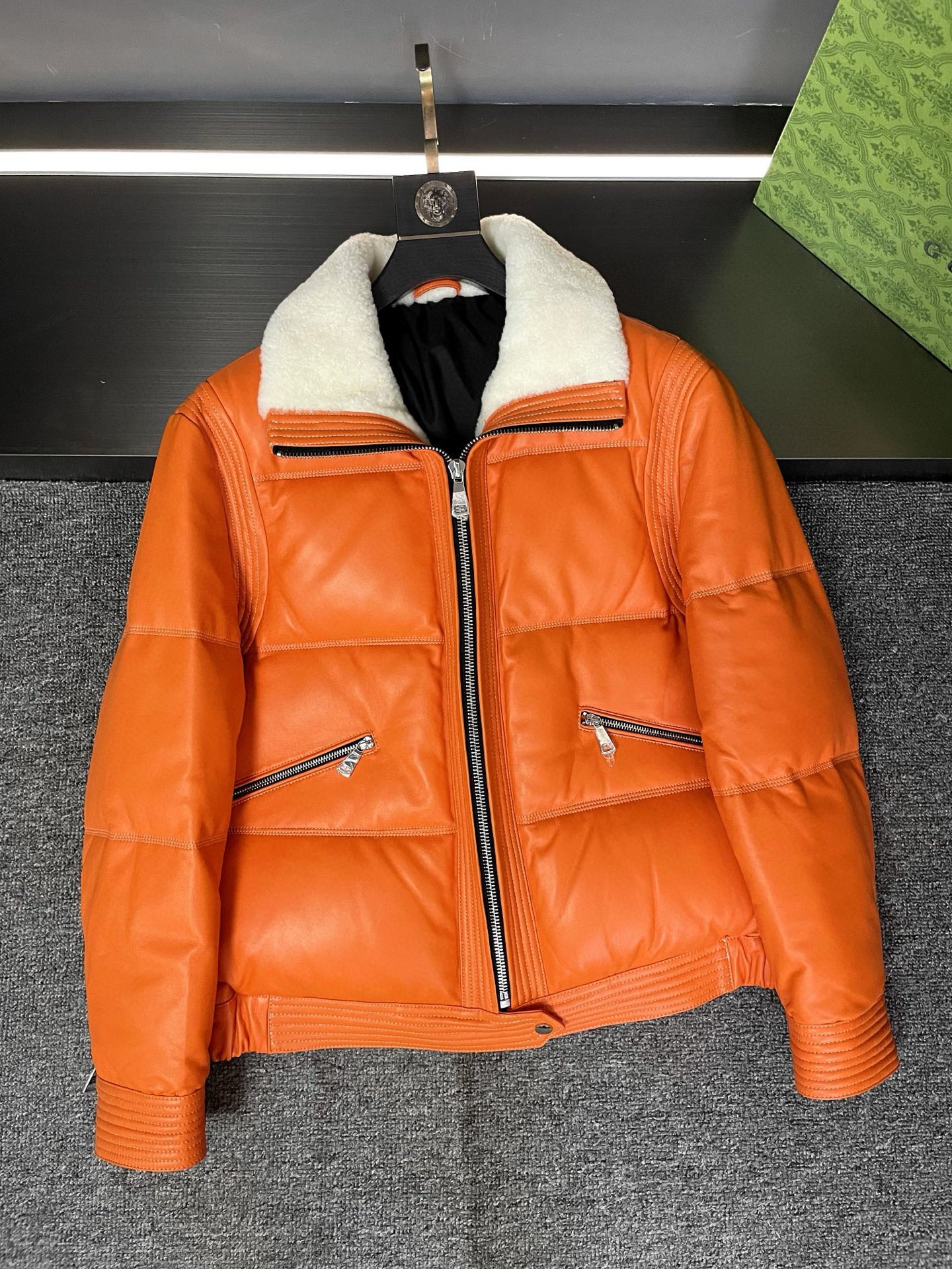 NO:674707,Hermès new autumn and winter sheepskin down jacket, tile detail Hermès, a brand with a century-old legendary history. Since its founding in 1837, Hermès has always been a leader in the fashion industry with its exquisite craftsmanship, top quality and unique design style. Every Hermès work carries the heritage and innovation of the brand, and is a perfect fusion of fashion and classics.  This sheepskin down jacket is carefully made of sheepskin imported from Australia and has an extraordinary texture. Filled with goose down, it is light and warm, allowing you to feel the ultimate warmth and comfort in the cold autumn and winter. It is available in two fashionable colors, black and orange, to meet different fashion tastes. The white lambskin collar extends along the placket to the hem, which not only adds warmth and softness, but also adds a touch of playfulness and cuteness to the overall look.  The details show the brand's ingenuity. Exquisite stitching, high-quality zippers, every detail demonstrates Hermès' persistent pursuit of quality. Wearing this Hermès sheepskin down jacket, you will become the fashion focus on the street, exuding confidence and elegance. Whether paired with casual pants or a skirt, you can easily create a fashionable and comfortable autumn and winter look. Don't hesitate anymore, come and experience the luxurious experience brought by Hermès' new autumn and winter sheepskin down jacket.  Size 48-56,,hermes,hermes,skirts,down jacket,sheepskin,Top Customize119860909爱马仕 HERMES 秋冬新款羊皮羽绒服,平铺细节图  爱马仕,一个拥有着百年传奇历史的品牌.自 1837 年创立以来,爱马仕始终以精湛的工艺、顶级的品质和独特的设计风格,成为时尚界的翘楚.每一件爱马仕的作品都承载着品牌的传承与创新,是时尚与经典的完美融合.  这款羊皮羽绒服采用澳洲进口羊皮精心打造,质感非凡.鹅绒填充,轻盈又保暖,让你在寒冷的秋冬季节也能感受到极致的温暖与舒适.有黑色和橙色两个时尚颜色可供选择,满足不同的时尚品味.而白色羊羔毛领沿门襟一直延伸到下摆,不仅增添了一份温暖与柔软,更是为整体造型增添了一抹俏皮与可爱.  细节之处尽显品牌的匠心独运.精致的缝线、高品质的拉链,每一个细节都彰显着爱马仕对品质的执着追求.  穿上这款爱马仕羊皮羽绒服,你将成为街头的时尚焦点,散发着自信与优雅的魅力.无论是搭配休闲裤还是裙装,都能轻松打造出时尚又舒适的秋冬造型.  别再犹豫了,快来感受爱马仕 秋冬新款羊皮羽绒服带来的奢华体验吧.  码数48-56,,hermes,hermes,skirts,down jacket,sheepskin,Top Customize1,Men's clothing