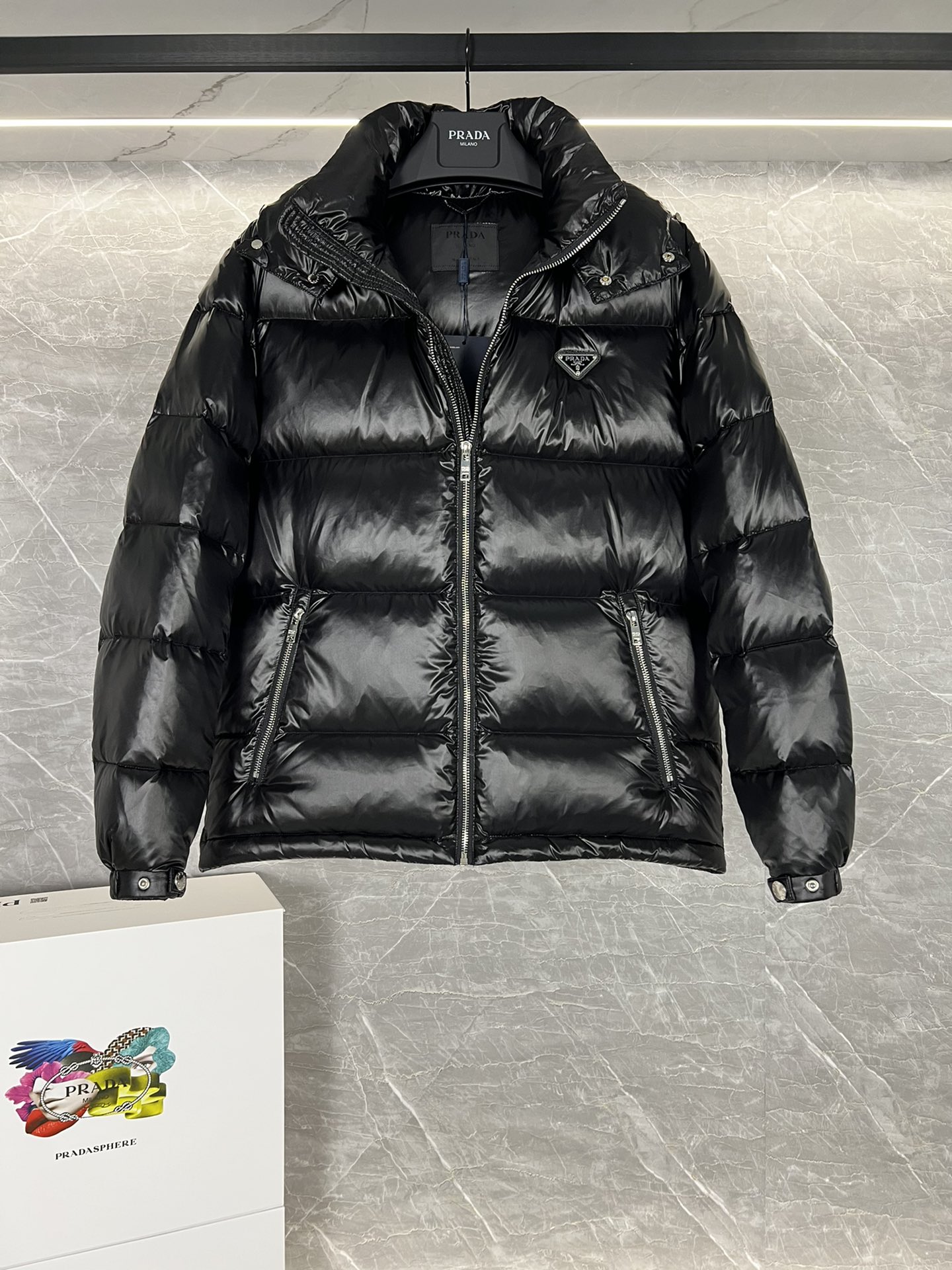 Top Prada Re-Nylon Thick Jacket with 90% down filling. Minimalist design, recycled material. Sizes 48-56, colors black and blue.-Big cat
