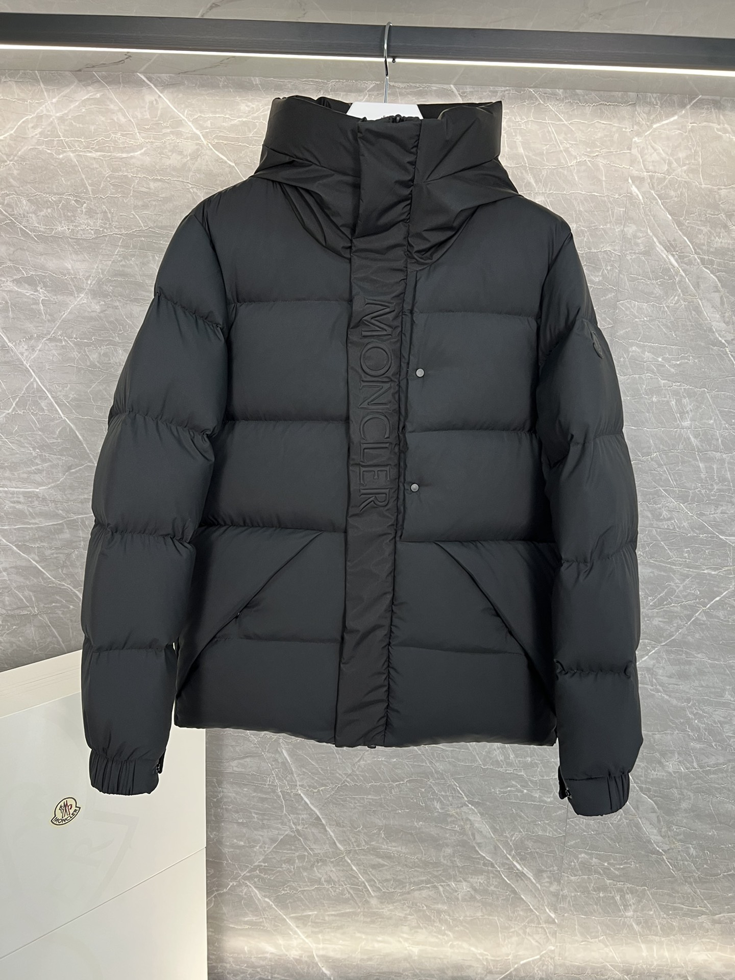 Top Moncler Madeira short down jacket for men and women, designed for adventure and warmth. Functional, stylish, suitable for street or ski wear. Features durable nylon, hood, down filling, snap/zip closure, zippered pockets, elastic hem. Sizes 1-5, two colors.-Big cat