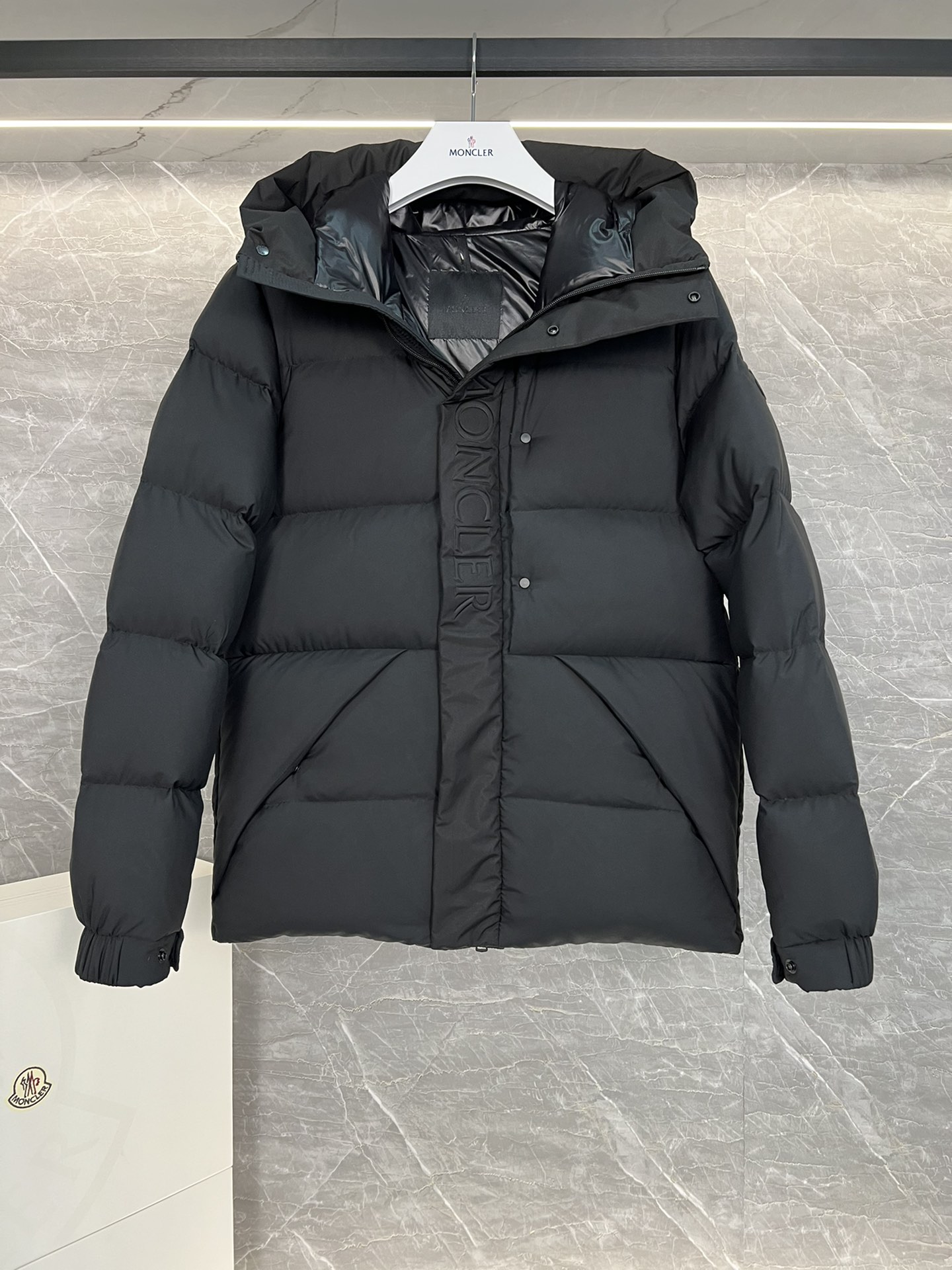 Top Moncler Madeira short down jacket for men and women, designed for adventure and warmth. Functional, stylish, suitable for street or ski wear. Features durable nylon, hood, down filling, snap/zip closure, zippered pockets, elastic hem. Sizes 1-5, two colors.-Big cat