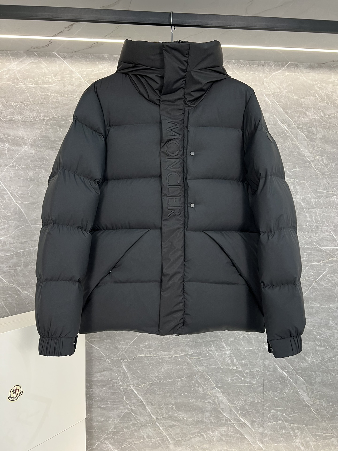 Top Moncler Madeira short down jacket for men and women, designed for adventure and warmth. Functional, stylish, suitable for street or ski wear. Features durable nylon, hood, down filling, snap/zip closure, zippered pockets, elastic hem. Sizes 1-5, two colors.-Big cat