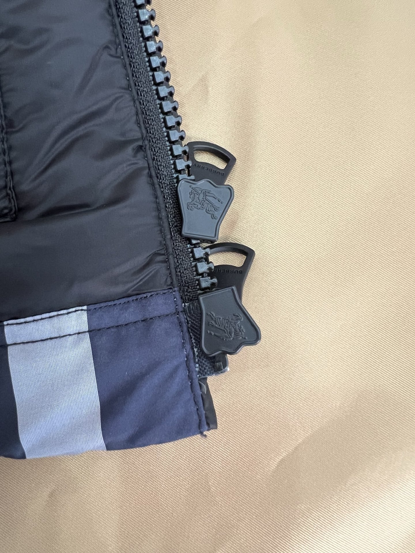 Guangzhou high-end Burberry down jacket for Winter 2025. Premium version with iconic check, high collar, removable hood, and water-resistant fabric. Available in versatile colors and sizes M-XXXL. Limited stock!-Big cat