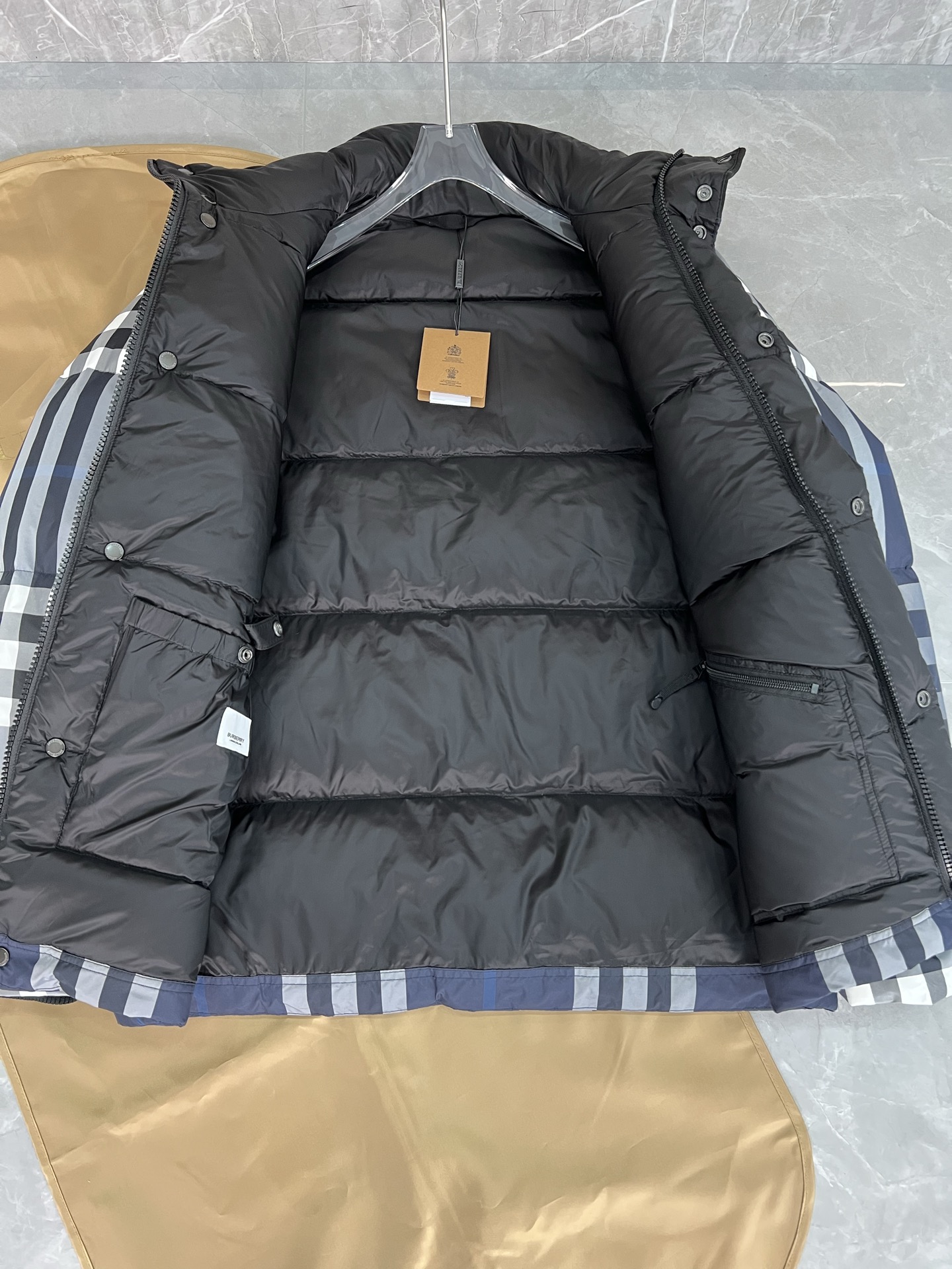 Guangzhou high-end Burberry down jacket for Winter 2025. Premium version with iconic check, high collar, removable hood, and water-resistant fabric. Available in versatile colors and sizes M-XXXL. Limited stock!-Big cat