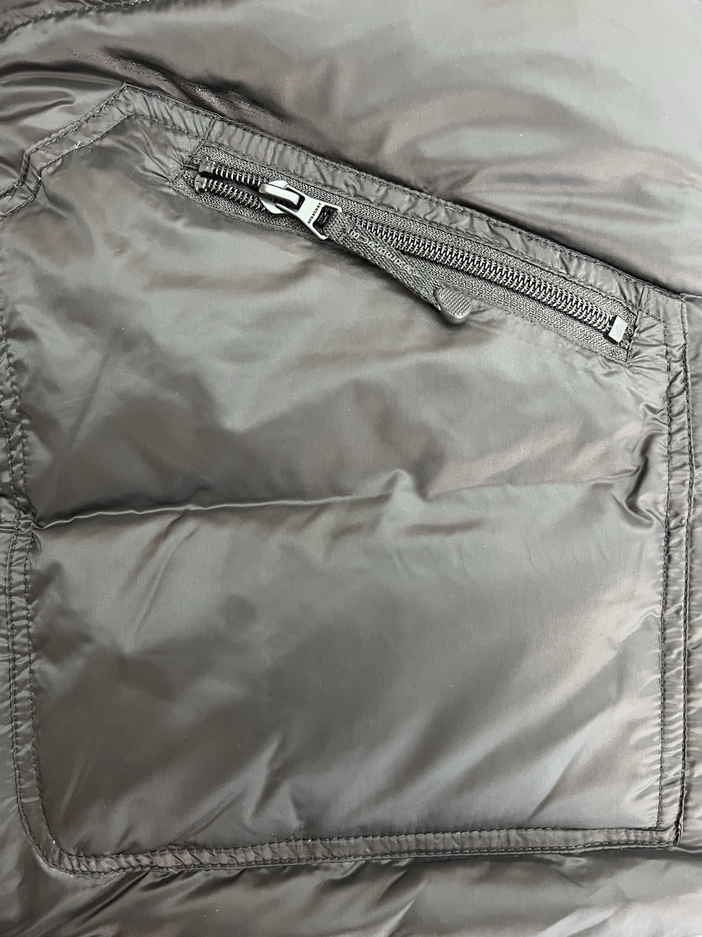 Guangzhou high-end Burberry down jacket for Winter 2025. Premium version with iconic check, high collar, removable hood, and water-resistant fabric. Available in versatile colors and sizes M-XXXL. Limited stock!-Big cat