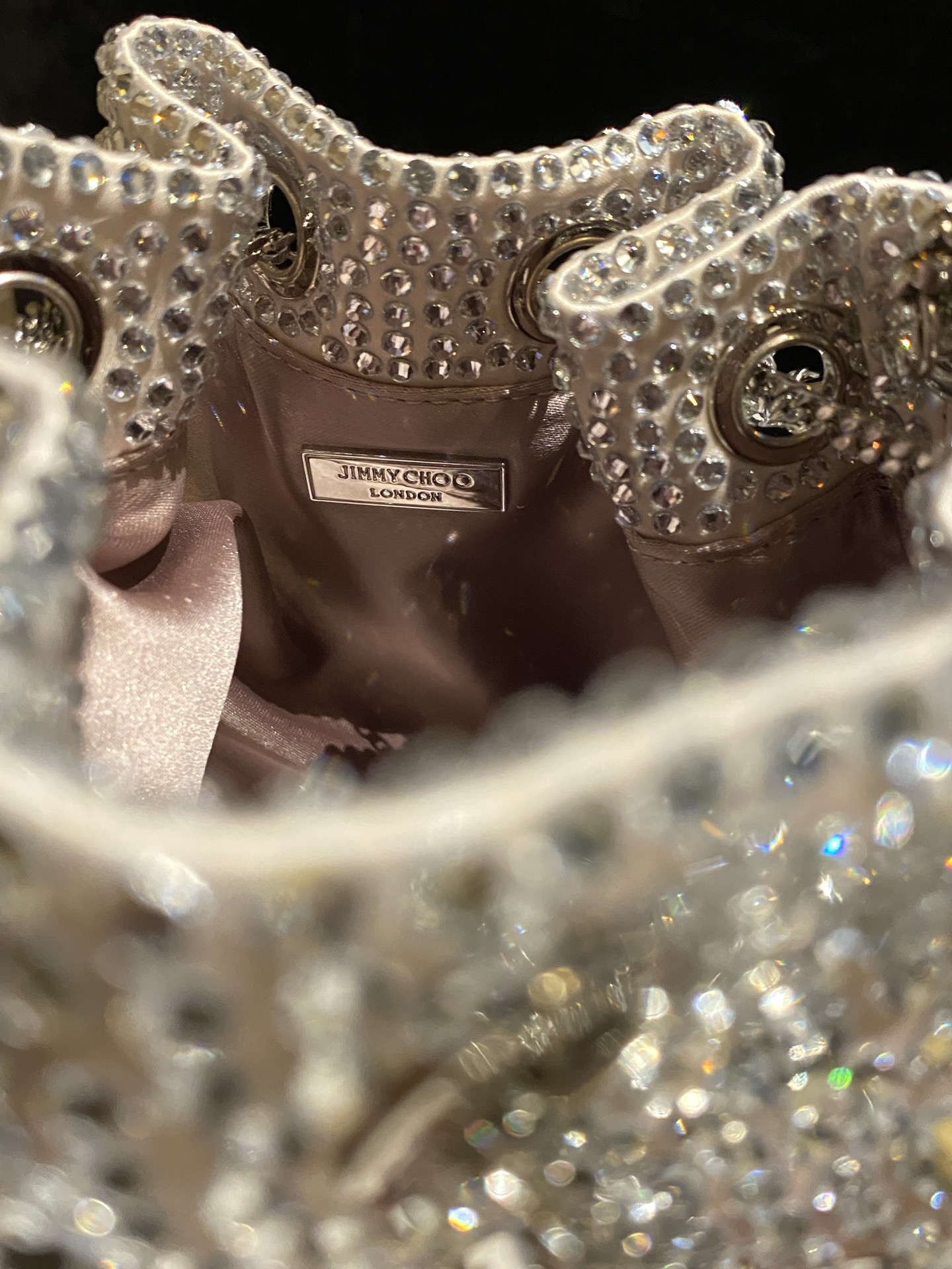 JIMMY CHOO
BON BON系列标志款手提包,光滑缎面铺嵌渐变水晶制作。
设计灵感源于软硬质感及甜美与张扬气质的强烈对比,点睛配以标志性金属流苏,成就如BON BON之名般个性别致又优雅迷人的时尚包袋。现代感桶包廓形,配以手环造型顶部提手,提手饰有百粒经三天精工颗颗细嵌的水晶,精美雅致,招牌奢华包袋当属本款BON BON手提包。
缎面烫钻水晶手嵌水晶饰手环提手Jimmy Choo logo压印金属流苏开合链条肩带内层口袋包袋尺寸:16(长)x15(高)x9.5(宽)厘米肩带长度:55厘米提手长度:9厘米 20259