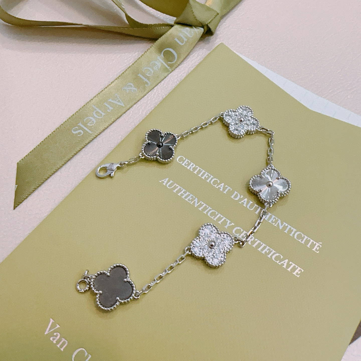 Van Cleef Arpels Alhambra bracelet silver-toned metal with clear diamond accents dark gray stone and silver guilloche clover motifs 19cm