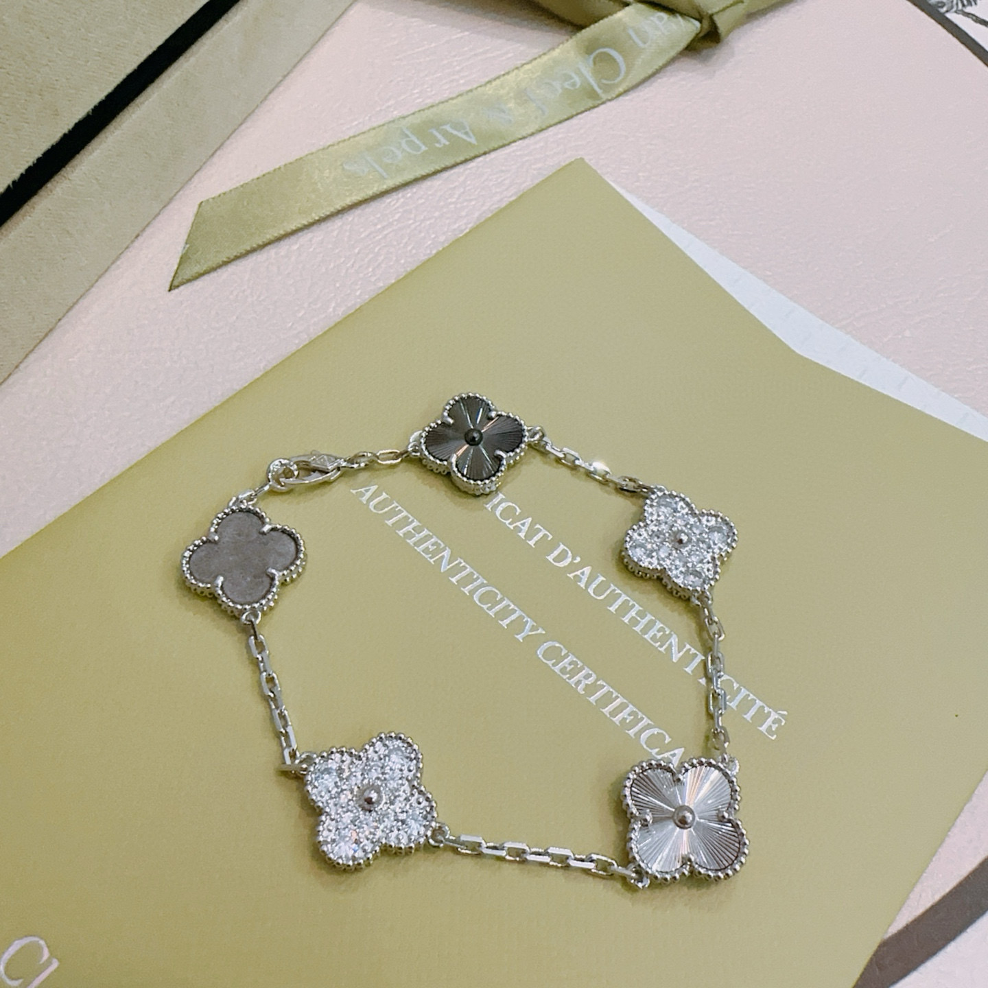 Van Cleef Arpels Alhambra bracelet silver-toned metal with clear diamond accents dark gray stone and silver guilloche clover motifs 19cm