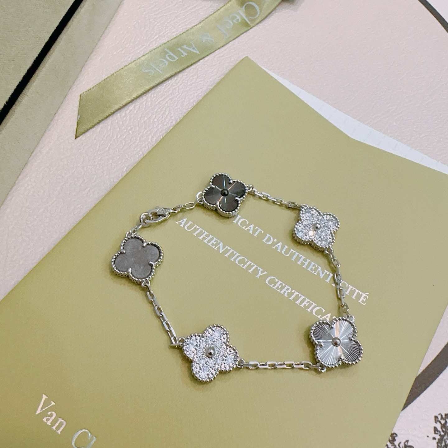 Van Cleef Arpels Alhambra bracelet silver-toned metal with clear diamond accents dark gray stone and silver guilloche clover motifs 19cm