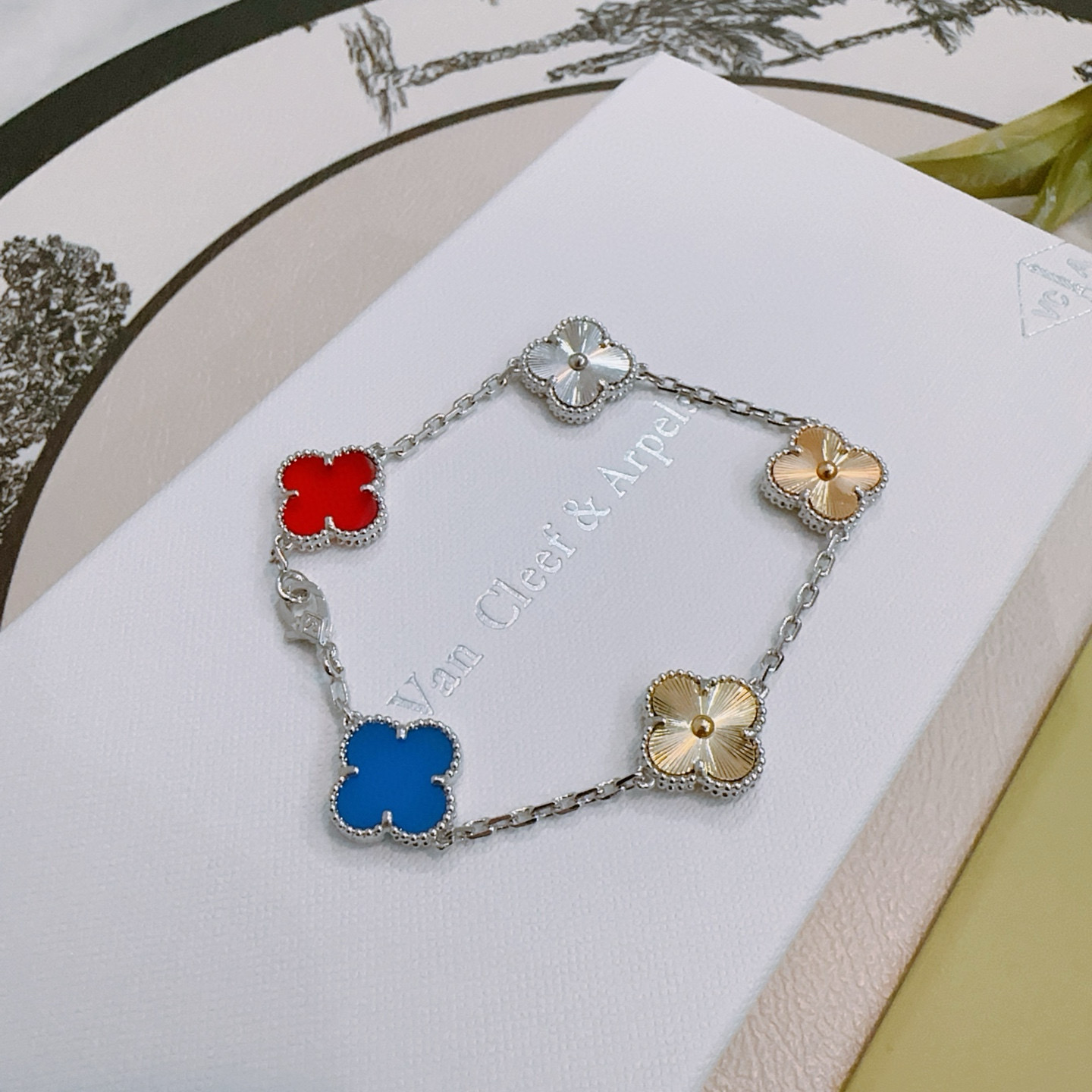 Van Cleef Arpels Alhambra bracelet Silver-toned metal with gold-toned accents red carnelian blue agate silver guilloche gold guilloche clover motifs 17cm