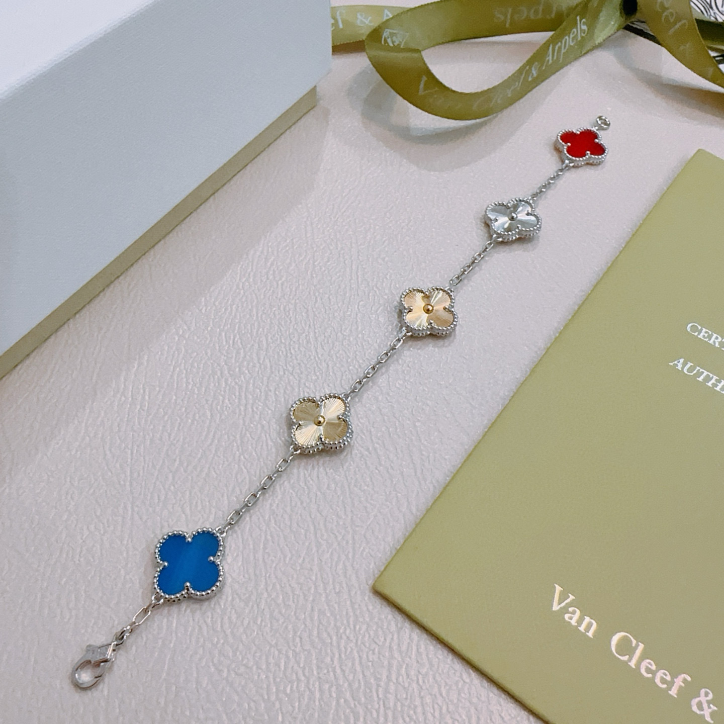 Van Cleef Arpels Alhambra bracelet Silver-toned metal with gold-toned accents red carnelian blue agate silver guilloche gold guilloche clover motifs 17cm