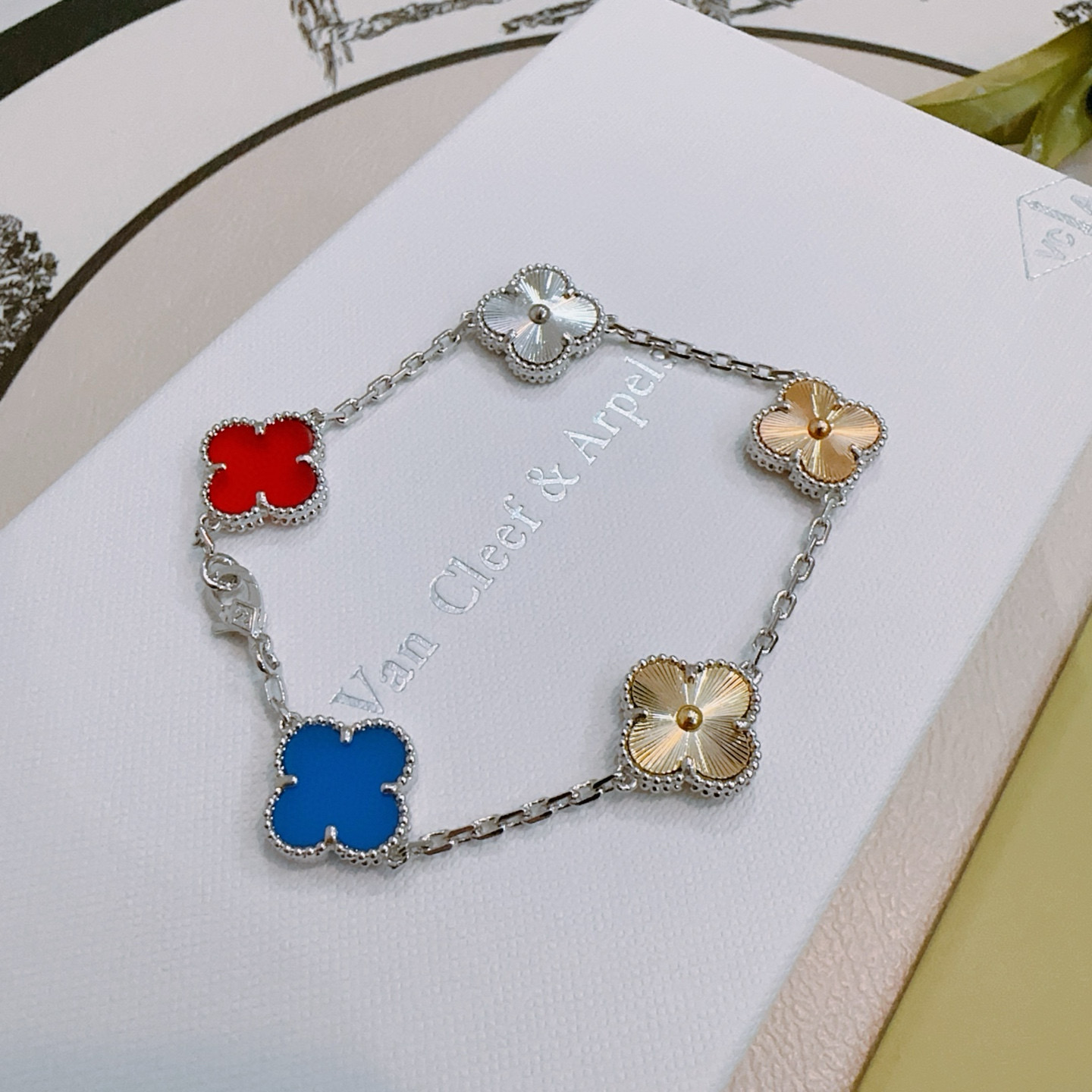 Van Cleef Arpels Alhambra bracelet Silver-toned metal with gold-toned accents red carnelian blue agate silver guilloche gold guilloche clover motifs 17cm