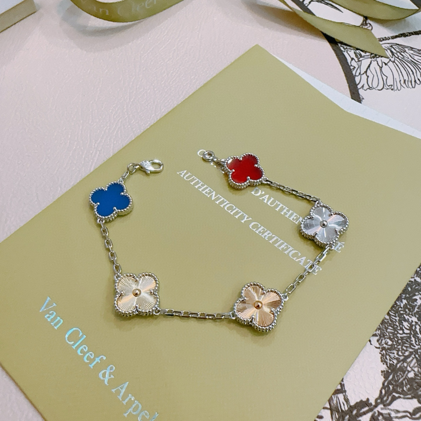 Van Cleef Arpels Alhambra bracelet Silver-toned metal with gold-toned accents red carnelian blue agate silver guilloche gold guilloche clover motifs 17cm