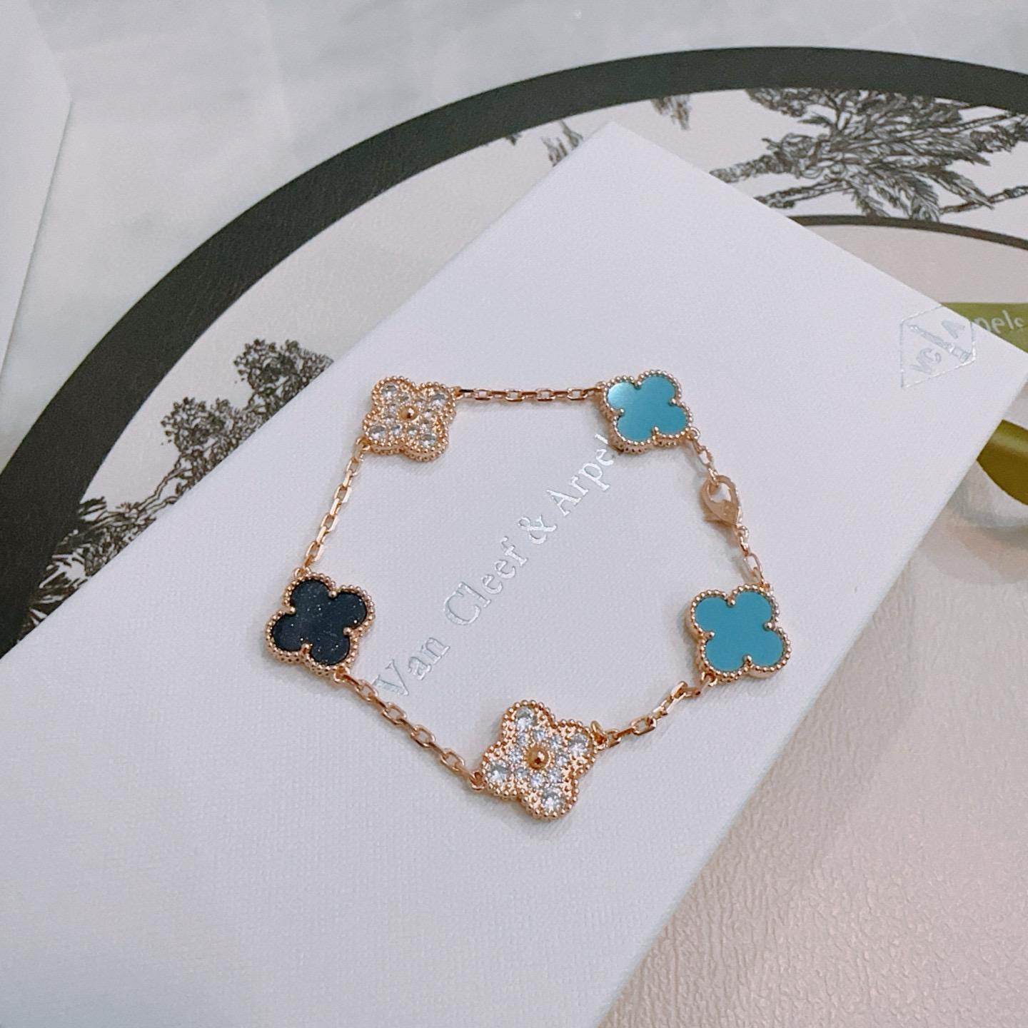 Van Cleef Arpels Alhambra bracelet Rose gold metal with turquoise blue black and clear diamond-accented four-leaf clover motifs 18cm