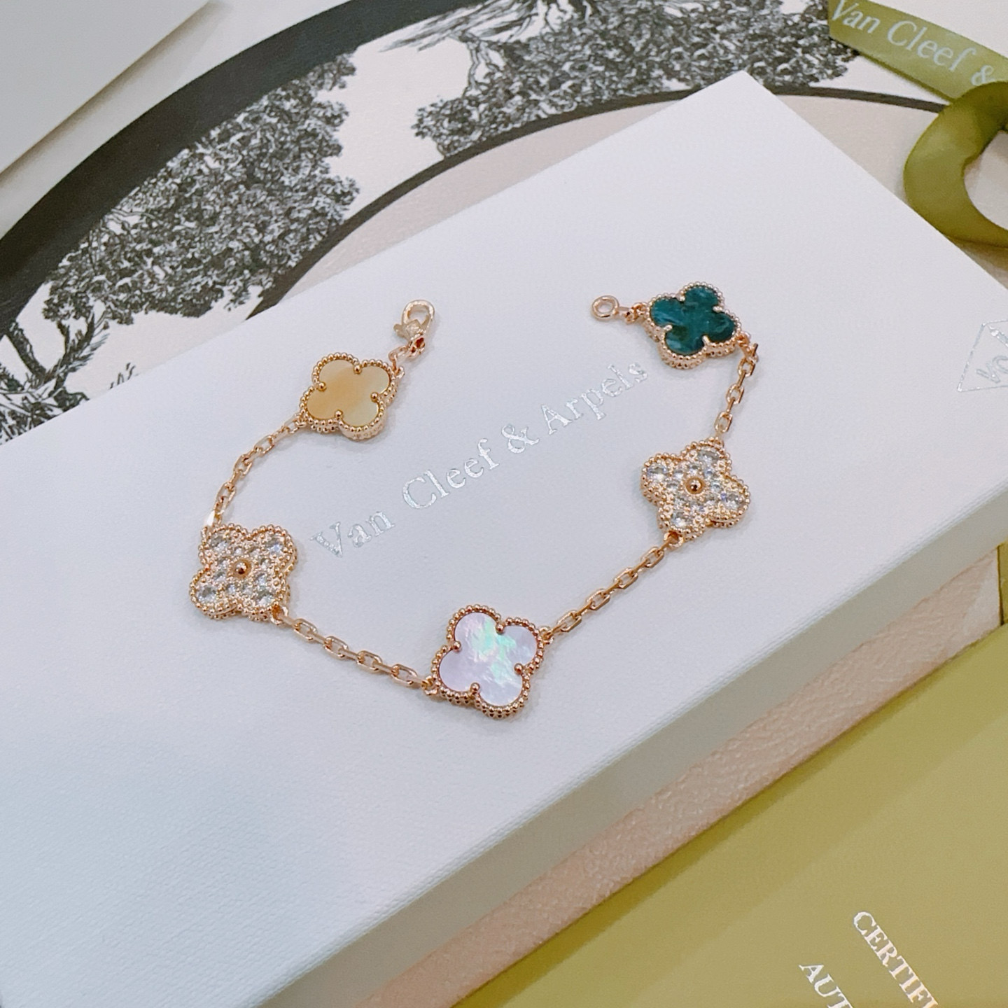 Van Cleef Arpels Alhambra bracelet Rose gold metal with white mother-of-pearl teal agate champagne mother-of-pearl opal and clear diamond accents 17cm