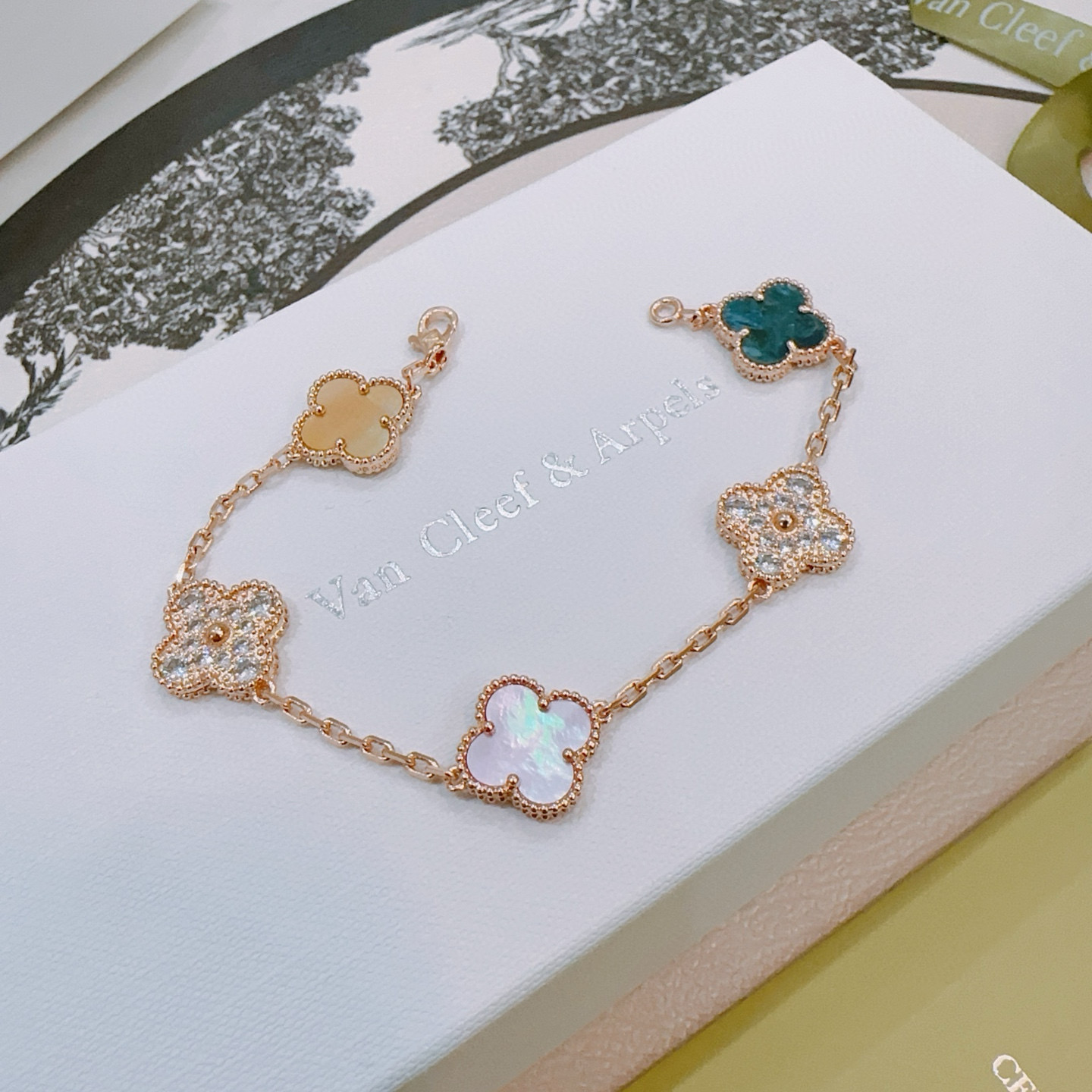 Van Cleef Arpels Alhambra bracelet Rose gold metal with white mother-of-pearl teal agate champagne mother-of-pearl opal and clear diamond accents 17cm