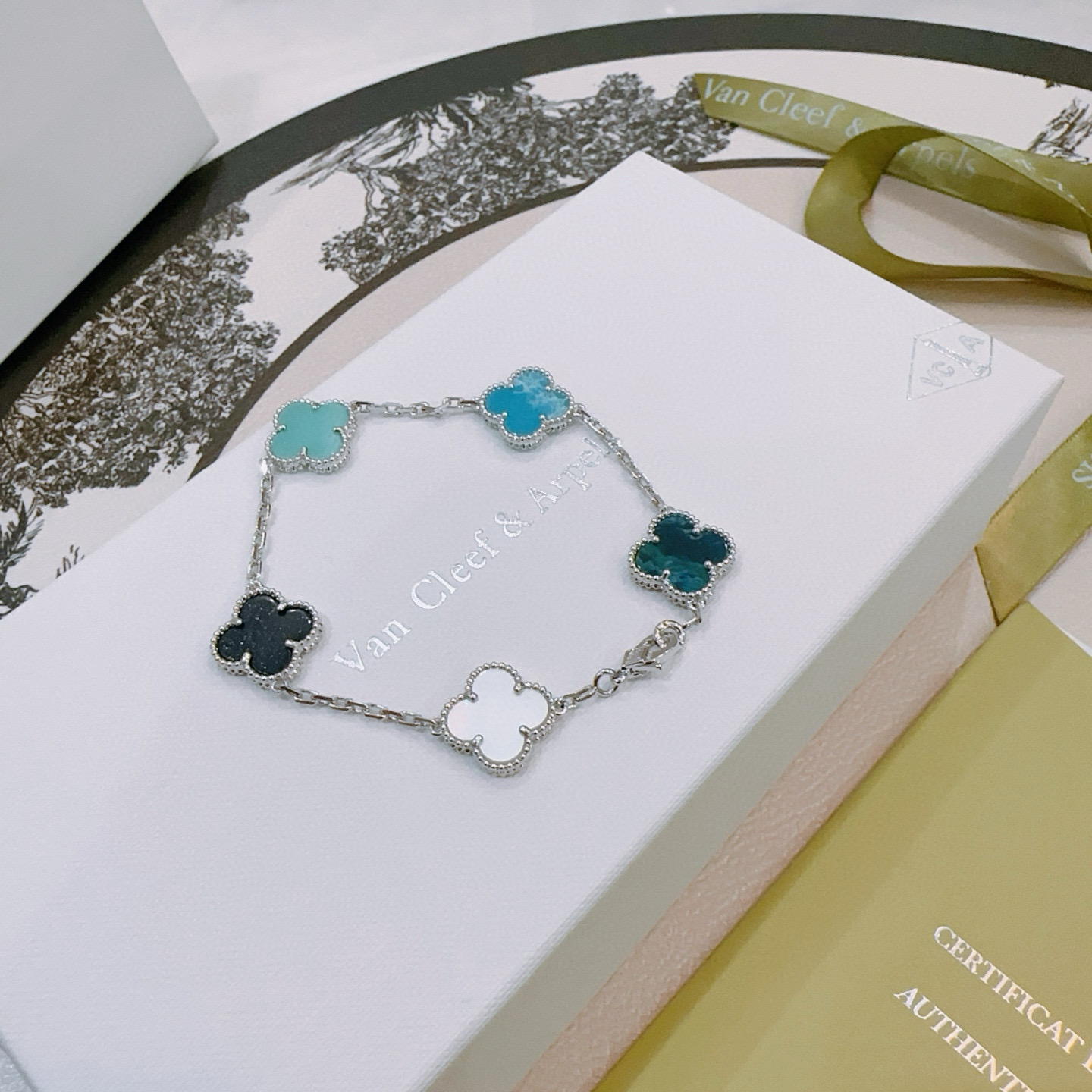 Van Cleef Arpels Alhambra bracelet Silver-toned metal with multicolor clover inlays white mother-of-pearl black onyx turquoise blue teal dark teal 17cm