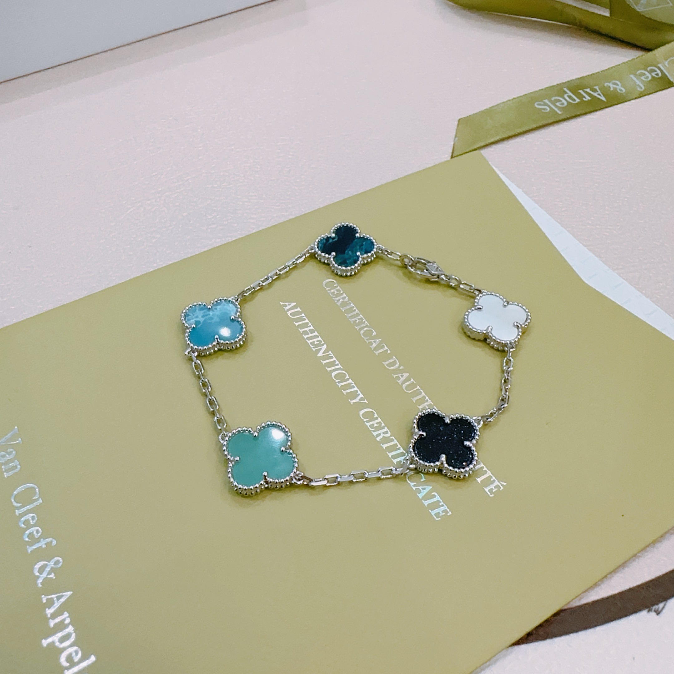 Van Cleef Arpels Alhambra bracelet Silver-toned metal with multicolor clover inlays white mother-of-pearl black onyx turquoise blue teal dark teal 17cm
