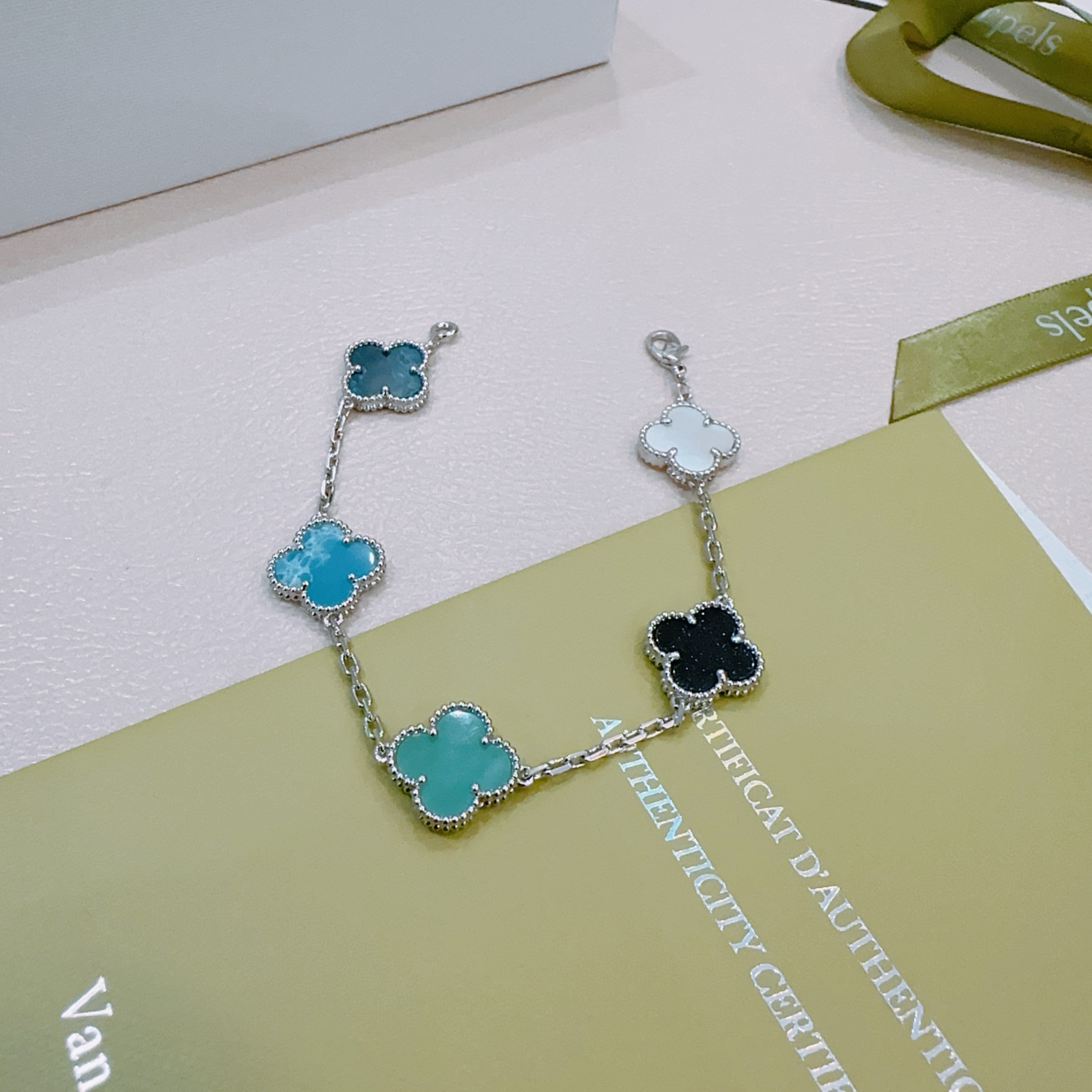 Van Cleef Arpels Alhambra bracelet Silver-toned metal with multicolor clover inlays white mother-of-pearl black onyx turquoise blue teal dark teal 17cm