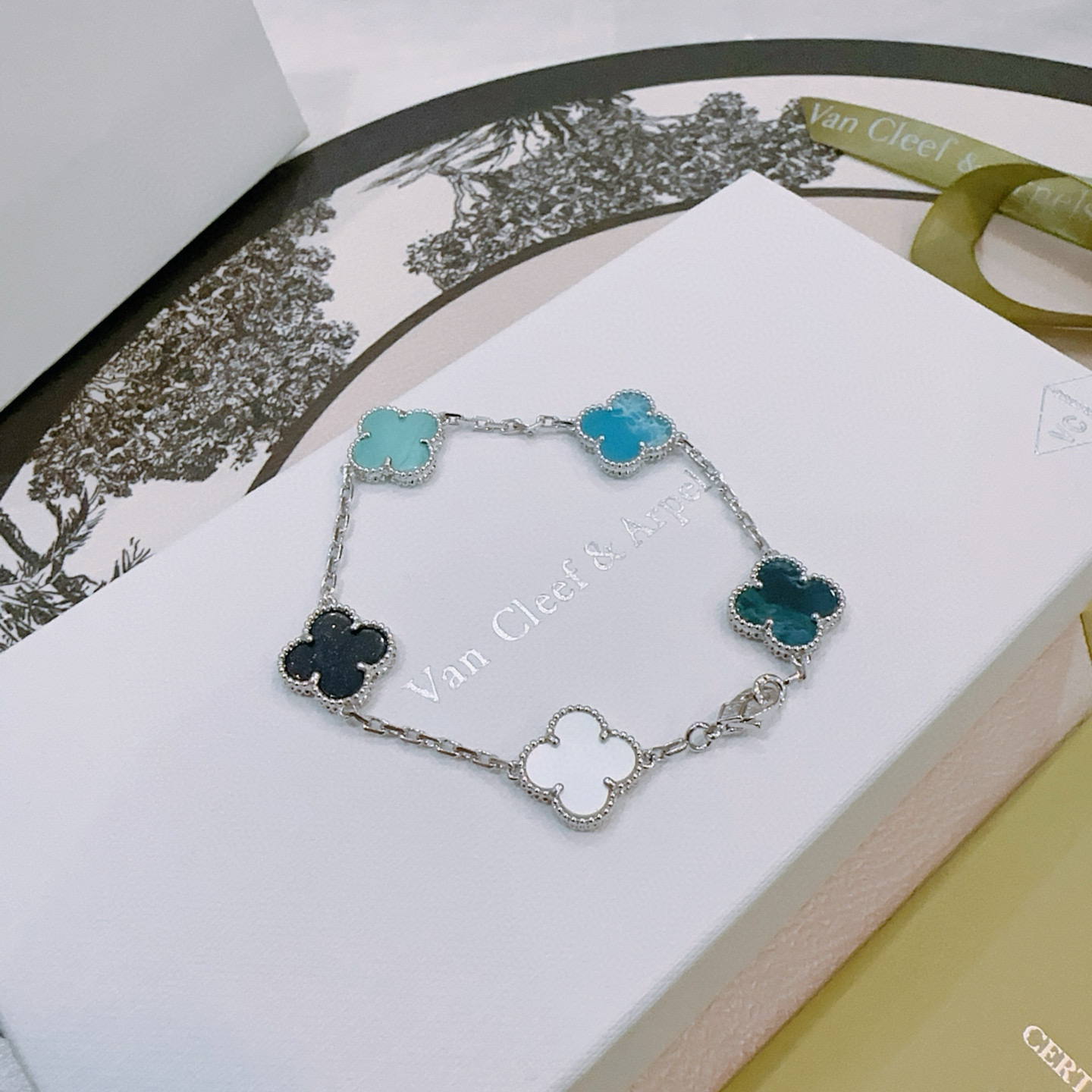 Van Cleef Arpels Alhambra bracelet Silver-toned metal with multicolor clover inlays white mother-of-pearl black onyx turquoise blue teal dark teal 17cm