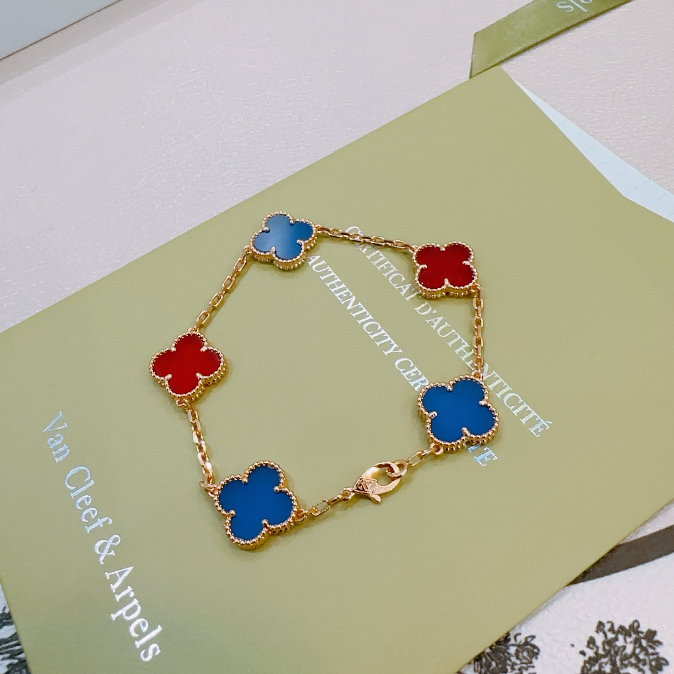 Van Cleef Arpels Alhambra bracelet Gold-toned metal with blue and red clover inlays 17cm