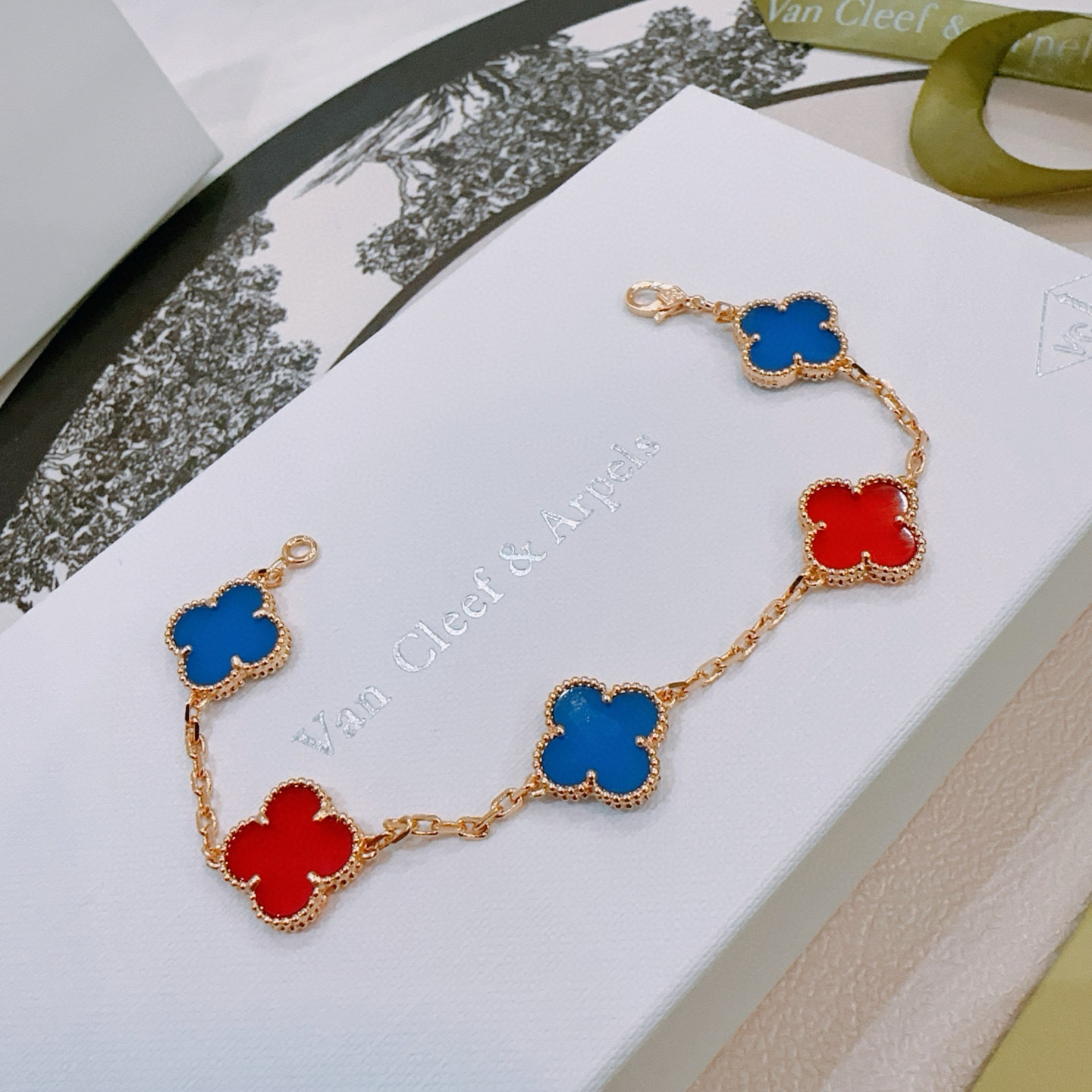 Van Cleef Arpels Alhambra bracelet Gold-toned metal with blue and red clover inlays 17cm