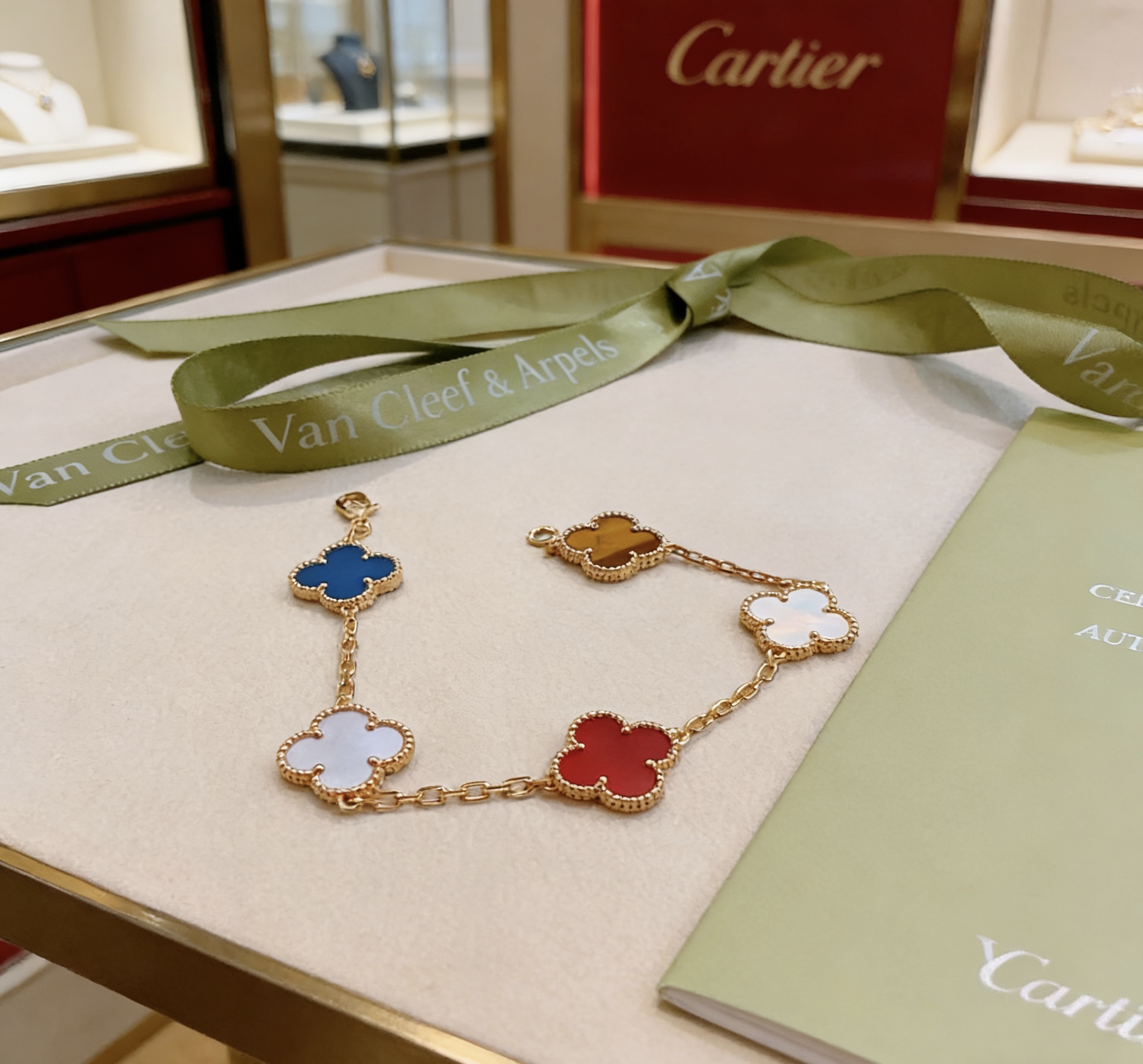 Van Cleef Arpels Alhambra bracelet Yellow gold metal with blue agate white mother-of-pearl red carnelian and tiger s eye stone clover motifs 19cm