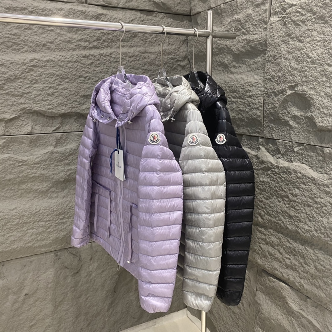 High-quality Moncler Raie short down jacket in black, gray, purple. Sizes 0-12. Streamlined design with waist drawstring, lightweight nylon quilting. Versatile style.-Big cat