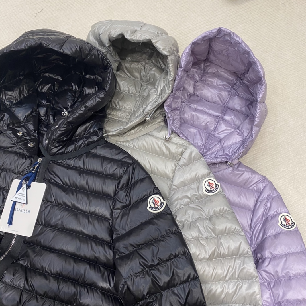 High-quality Moncler Raie short down jacket in black, gray, purple. Sizes 0-12. Streamlined design with waist drawstring, lightweight nylon quilting. Versatile style.-Big cat
