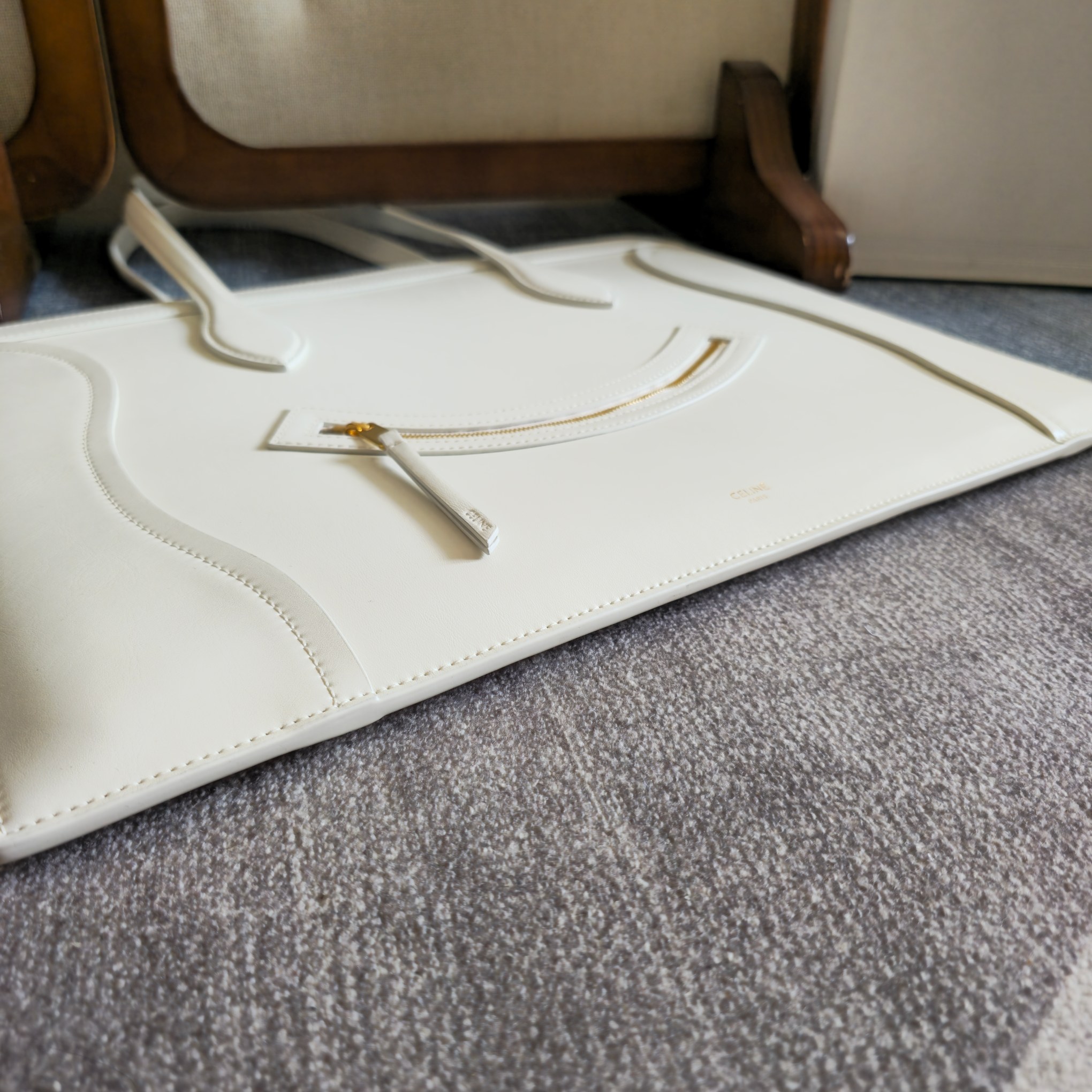 p750。 新品上线🅰️🅰️ 2026年春夏新款笑脸包. 
十几年前的 It Bag，Ce 笑脸包回归啦&hellip;&hellip;
Ce26春夏大秀，Michael Rider 将10年诞生、红极一时的&ldquo;笑脸包&rdquo;带回大众视野。
除了廓形变得更加窄长、囧脸变笑脸以外，还推出了超薄造型的 Flat Cabas 笑脸包。秀款中还有许多不同Size、配色亟待推出✅
款号：123963
颜色：白色
尺寸：44.5x31.5x0.5cm