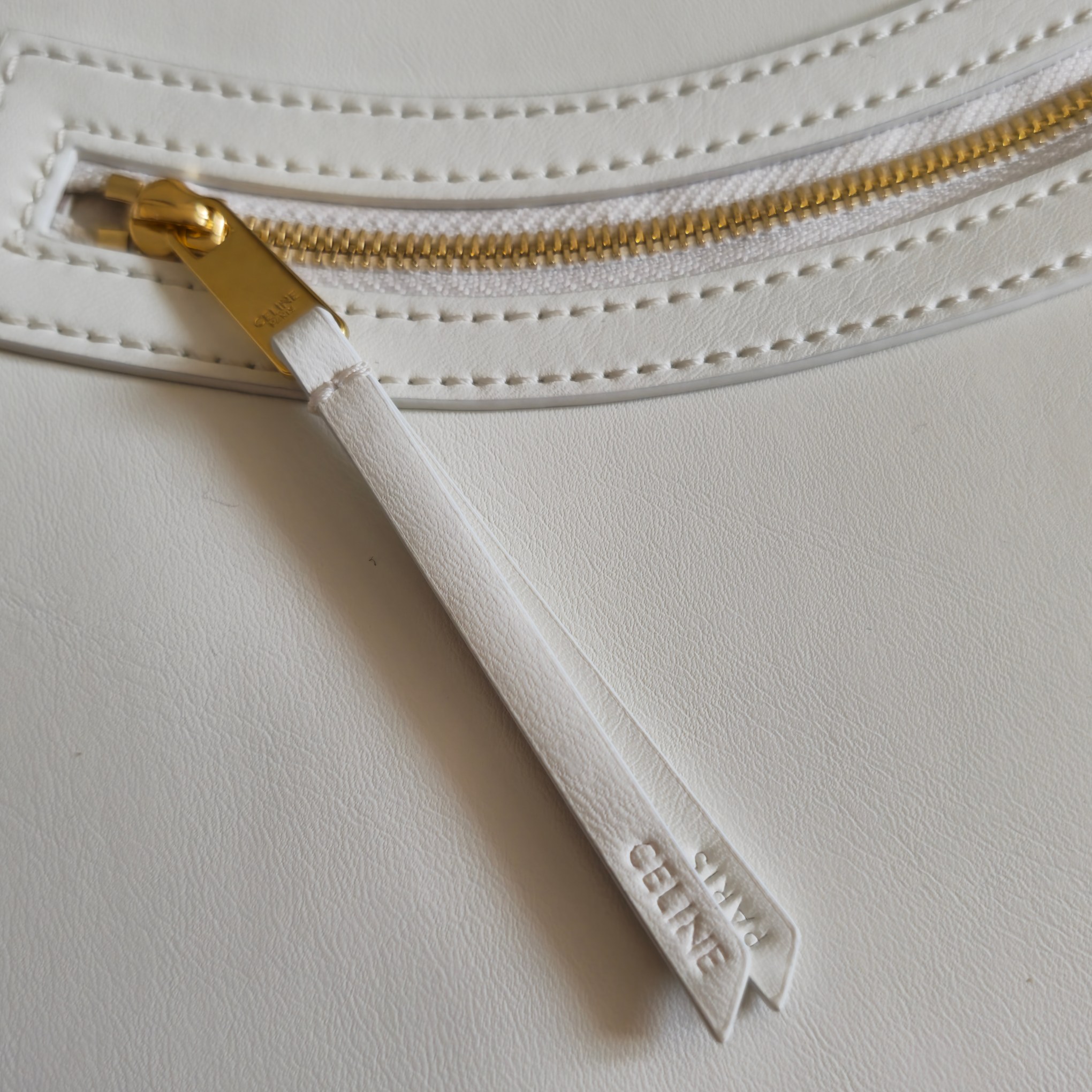 p750。 新品上线🅰️🅰️ 2026年春夏新款笑脸包. 
十几年前的 It Bag，Ce 笑脸包回归啦&hellip;&hellip;
Ce26春夏大秀，Michael Rider 将10年诞生、红极一时的&ldquo;笑脸包&rdquo;带回大众视野。
除了廓形变得更加窄长、囧脸变笑脸以外，还推出了超薄造型的 Flat Cabas 笑脸包。秀款中还有许多不同Size、配色亟待推出✅
款号：123963
颜色：白色
尺寸：44.5x31.5x0.5cm