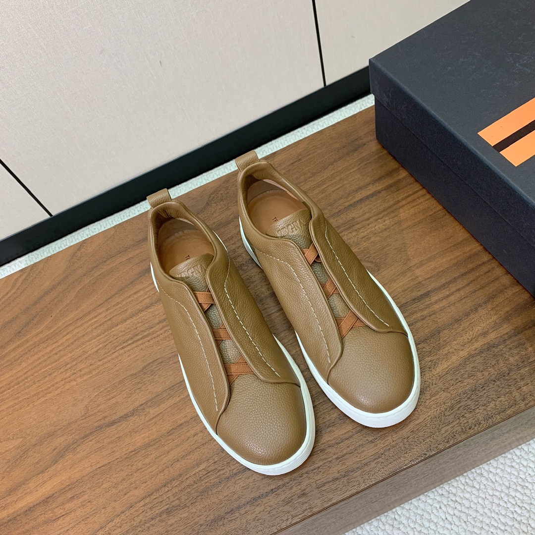 【Zegna】荔枝纹一脚蹬休闲鞋。饰有标志性三重交叉松紧细节，灵感源于三重手缝线迹造型，彰显了杰尼亚的悠