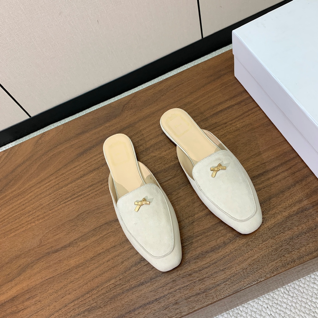 【D*or】蝴蝶结包头拖。修长方形鞋头和精致的金色饰面金属蝴蝶结装饰。采用绒面羊皮革精心制作，彰显舒适穿
