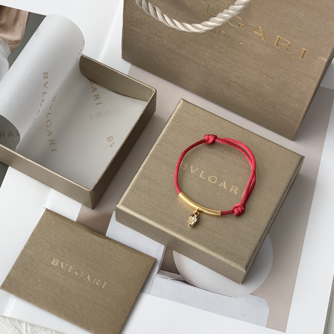 Featuring the iconic motif paired with a woven red cord, this bracelet - Jewelry