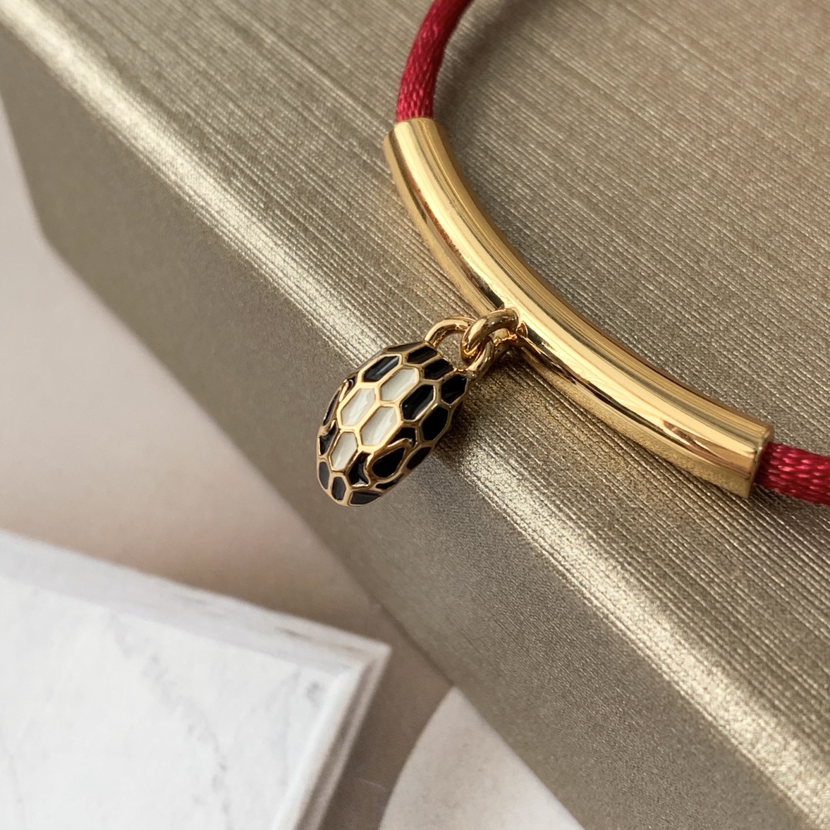 Featuring the iconic motif paired with a woven red cord, this bracelet - Jewelry 9