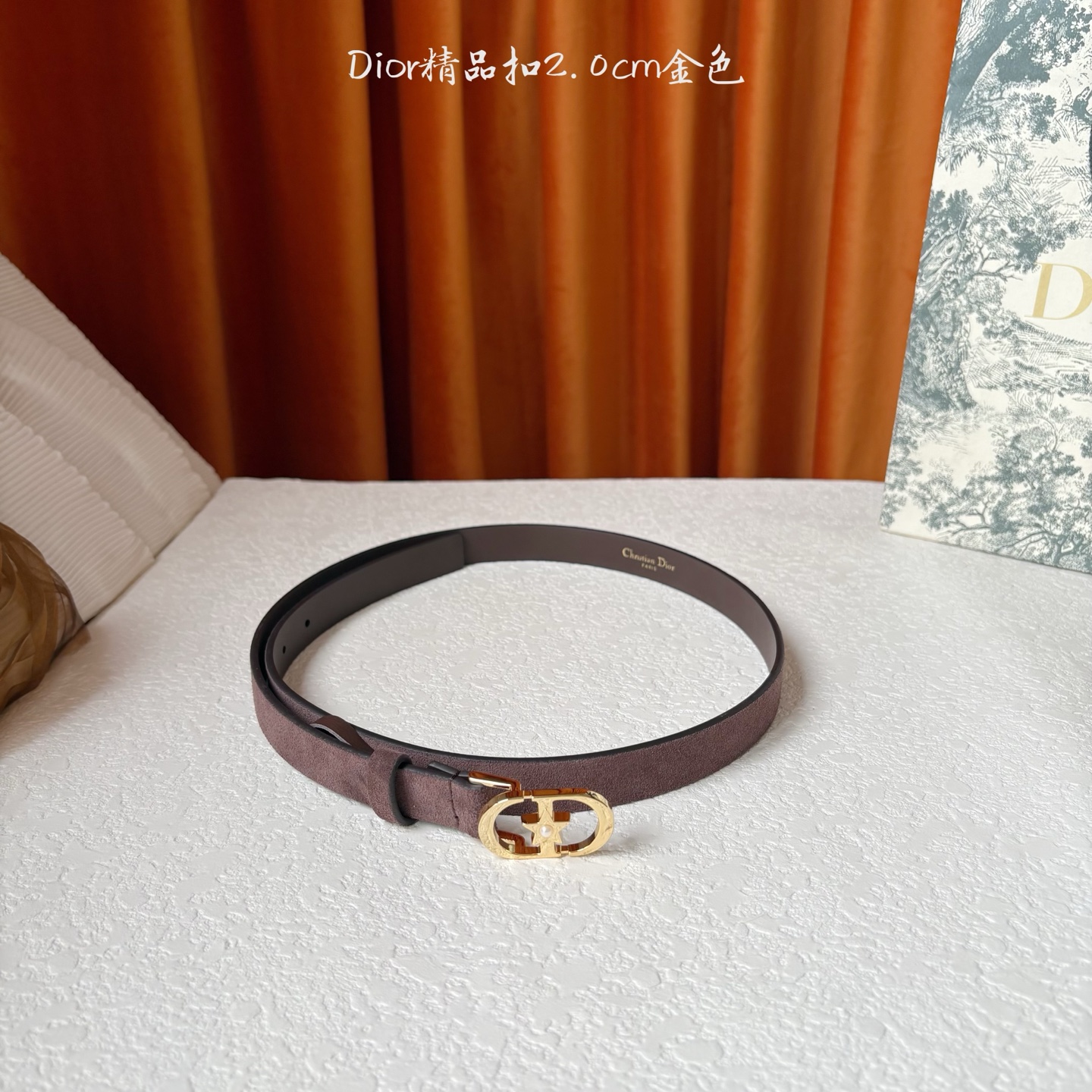 Dior的马鞍腰带已成为品牌的标志性款式，是每个衣橱的必备品。这款绒面小牛皮腰带重新演绎了这一经典款式，