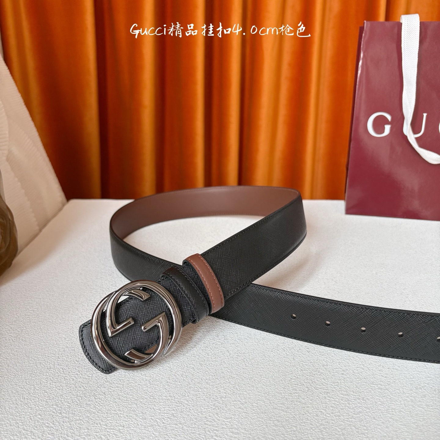 Gucci这款腰带一面为黑色粒面牛皮革，另一面为深棕色牛皮革，搭配可拆卸互扣式双G造型腰带扣，宽4.0c