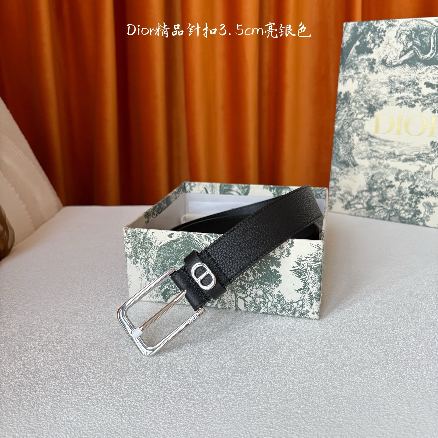 Dior这款腰带采用黑色粒面牛皮革精心制作，饰以镌刻有 Dior 的针扣和金属 CD Icon 标志腰带