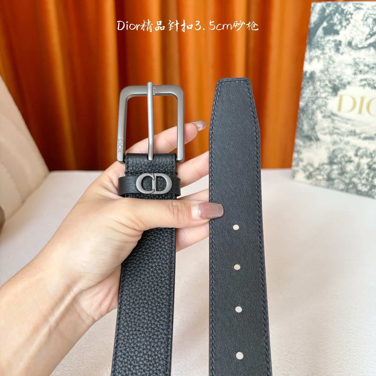 Dior这款腰带采用黑色粒面牛皮革精心制作，饰以镌刻有 Dior 的针扣和金属 CD Icon 标志腰带