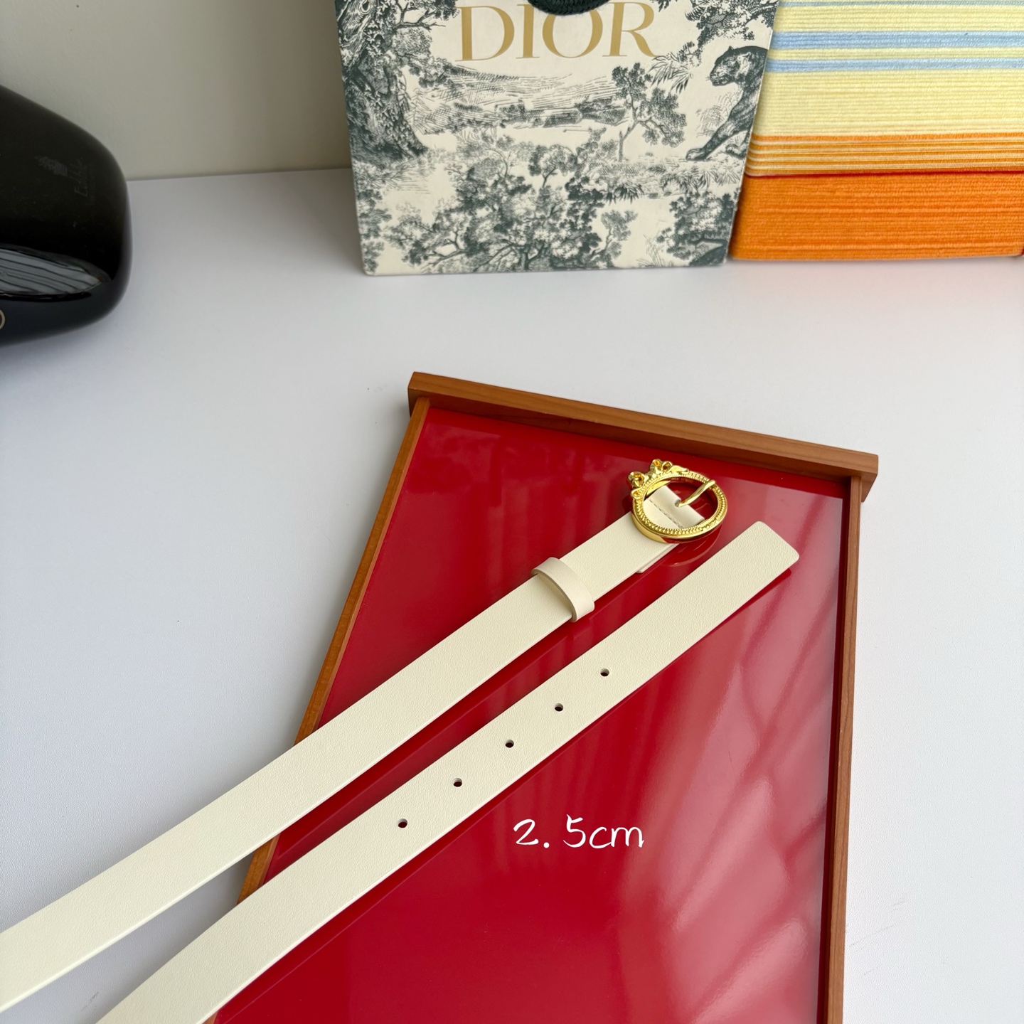 Dior 腰带以十八世纪洛可可风格演绎 Dior 沙龙的精致格调。采用光滑牛皮革精心制作，搭配复古色饰面