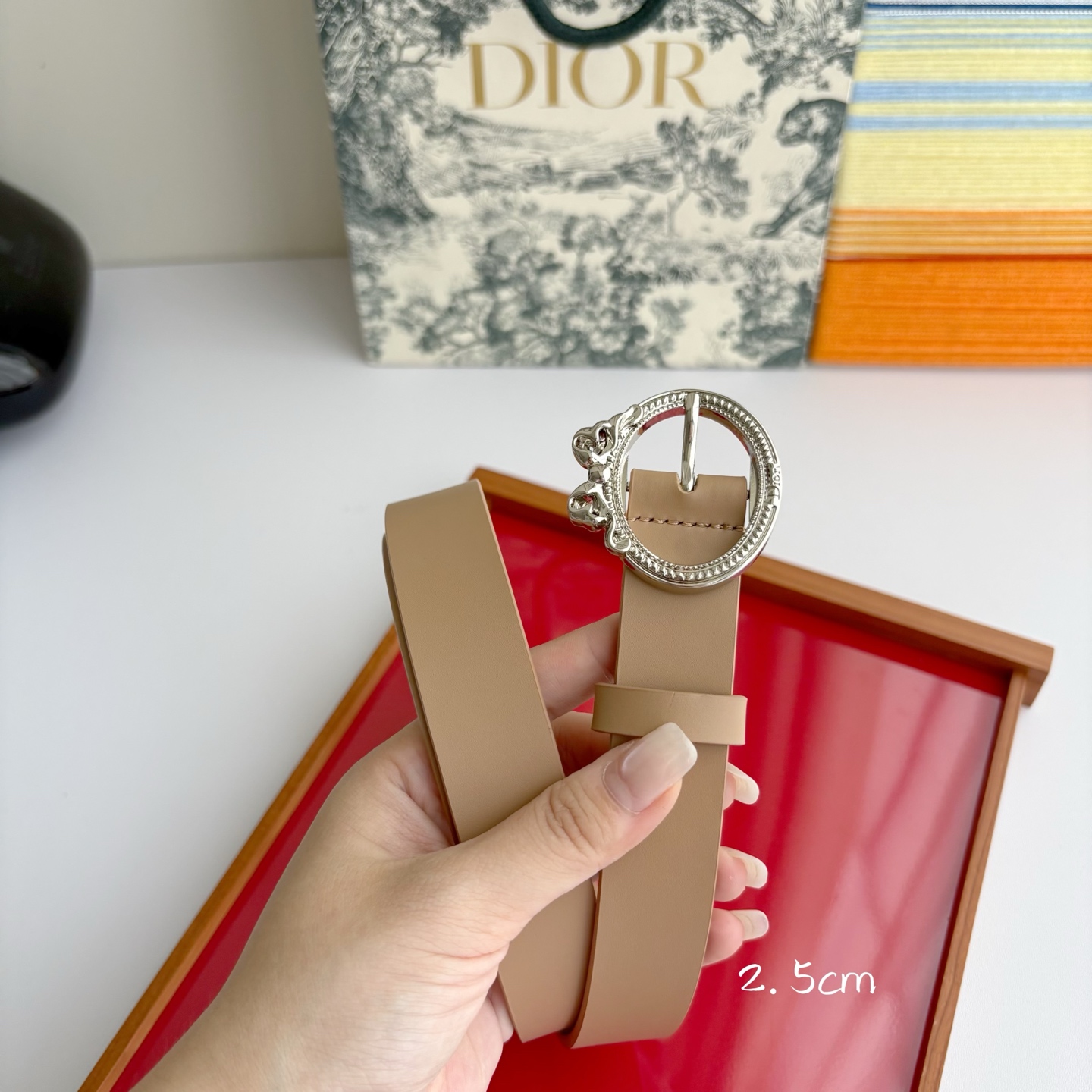 Dior 腰带以十八世纪洛可可风格演绎 Dior 沙龙的精致格调。采用光滑牛皮革精心制作，搭配复古色饰面