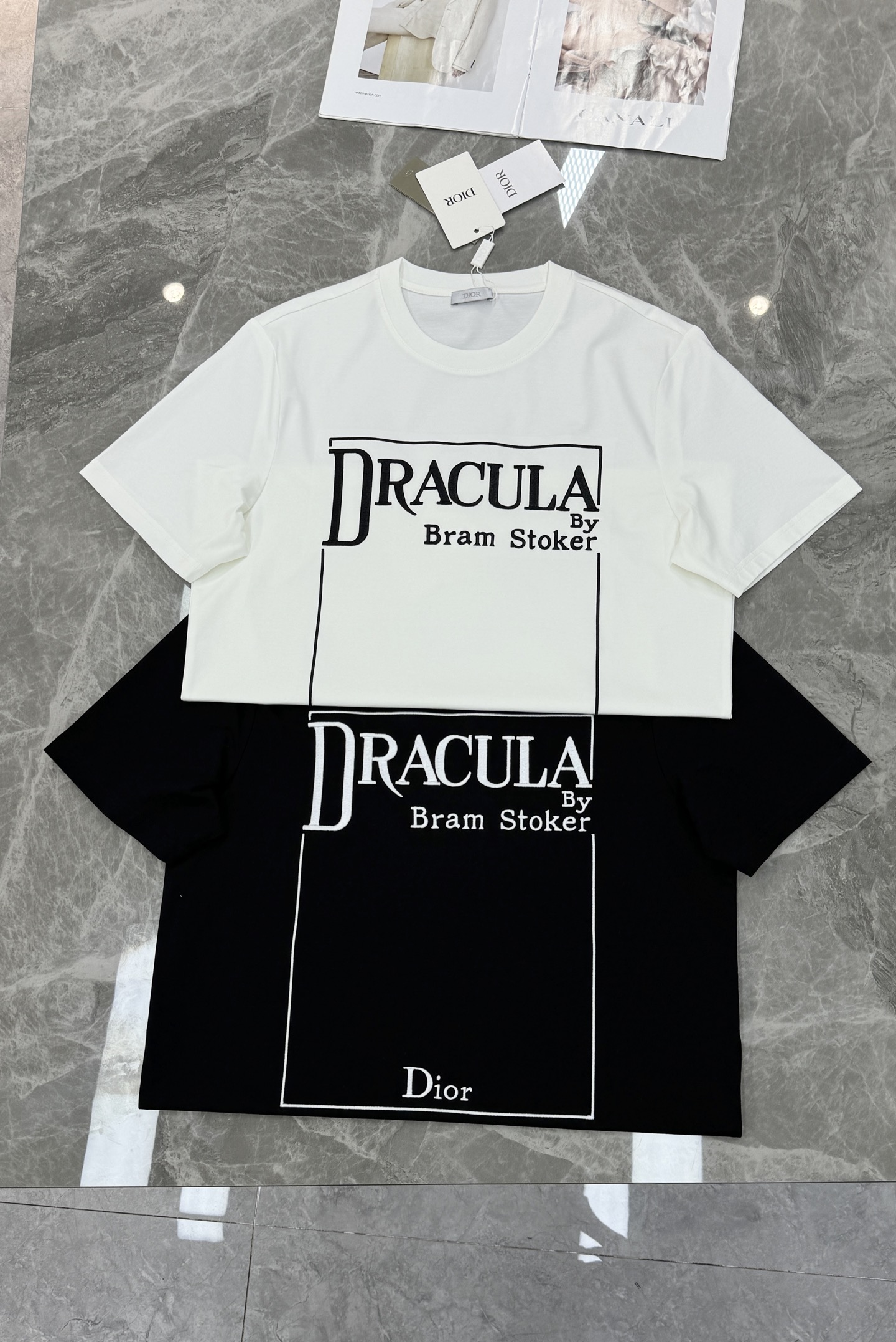 Dior推出的Dracula主题T恤，灵感源自斯托克小说《德古拉》。黑色款搭配白色字体，整体图形刺绣工艺