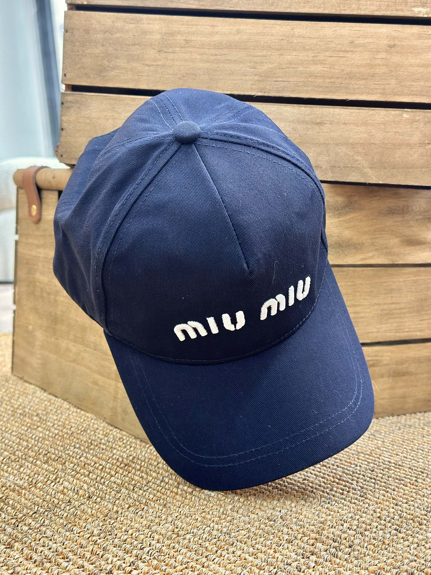 detailed with signature Miu Miu embroidery across the front and a - Comprehensive