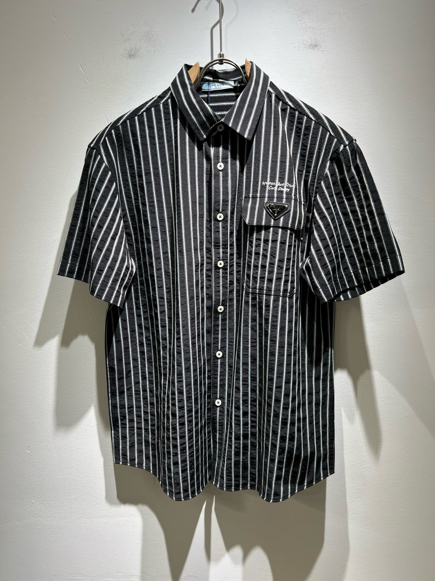 NO:453033,PRAD*A Pu*da 2025 spring and summer new casual men's shirt, the latest fashionable casual body logo hardware modification!  Trading companies have sparse channels and are released on the official website at the same time. The most anticipated high-quality products are coming, with high-end customized pure cotton materials!  Let you feel what is truly high luxury and connotation! This model is made of P-made professional custom fabrics, with a neat and smooth surface and luster. The texture is obvious through the screen. It perfectly enhances the overall luxury and class, and can get a high-end luxury atmosphere at a glance! Basic regular style cutting, versatile and simple upper body, and is easy to deal with various occasions and environments. It is undoubtedly a must-have item for daily commuting! Size M~4XL, prada, alexander wang19860909PRAD*A普*达2025春夏新款休闲男士衬衣,最新时尚休闲衣身logo五金修饰！贸易公司渠道稀出,同步官网发售,男神最为期待的精品狠货重磅来袭,高端定制纯棉材质！让你感受到什么叫真正的高奢有内涵!此款选用了P家专业定制面料制成,表面整洁光滑且富有光泽,质感透过屏幕都显而易 完美提升了整体的奢华档次感,一眼就能Get到的高端奢华气息!基础常规的版型裁剪,上身百搭简约不挑人,轻松应对各种场合与环境,属于日常通勤必备的臻品无疑!尺码M～4XL,,prada,alexander wang,Men's clothing