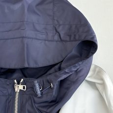Gucc*/古驰 25SS秋冬新款假两件连帽尼龙风衣夹克冷调金属边框与暖黄灯带交织,衬托夹克的低调光泽。 Gucc*/古驰 25SS秋冬新款假两件连帽尼龙风衣夹克冷调金属边框与暖黄灯带交织,衬托夹克的低调光泽。